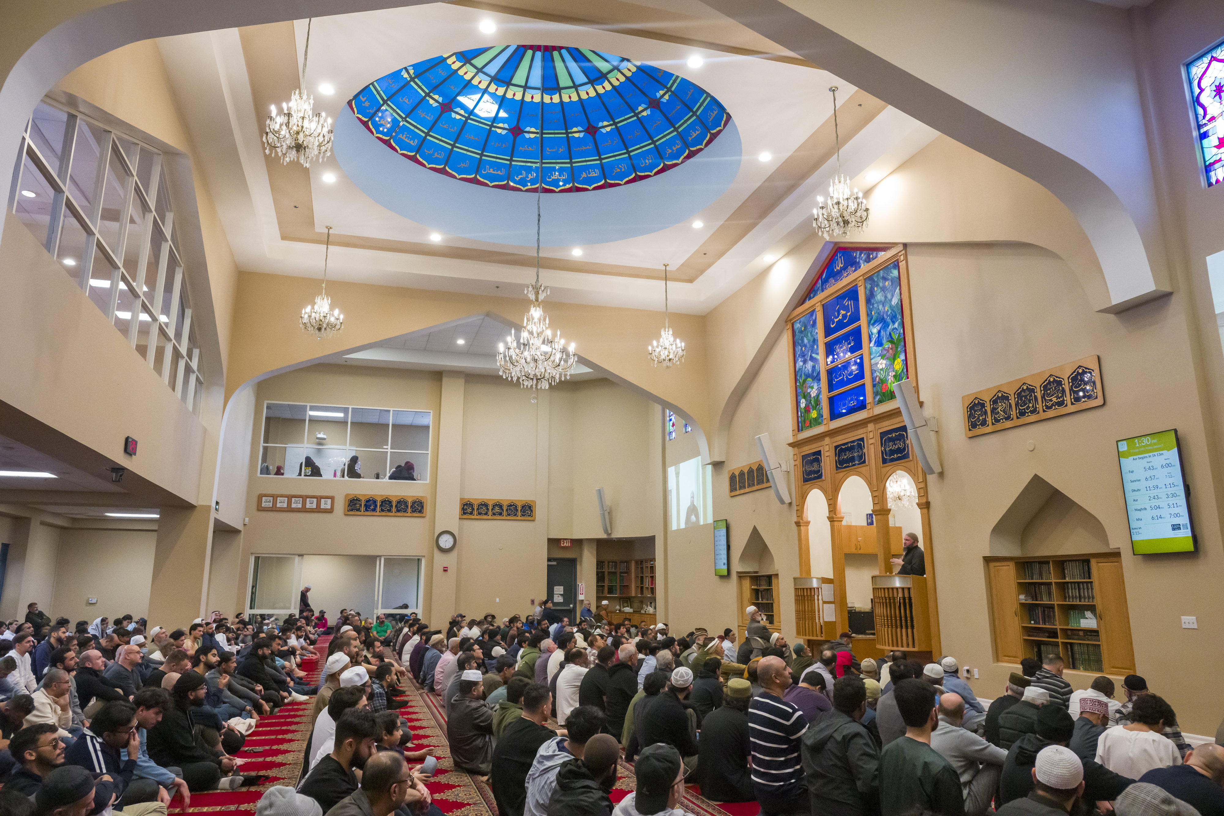 Imam Fayaz Nawabi, right, gives a sermon at the Islamic...