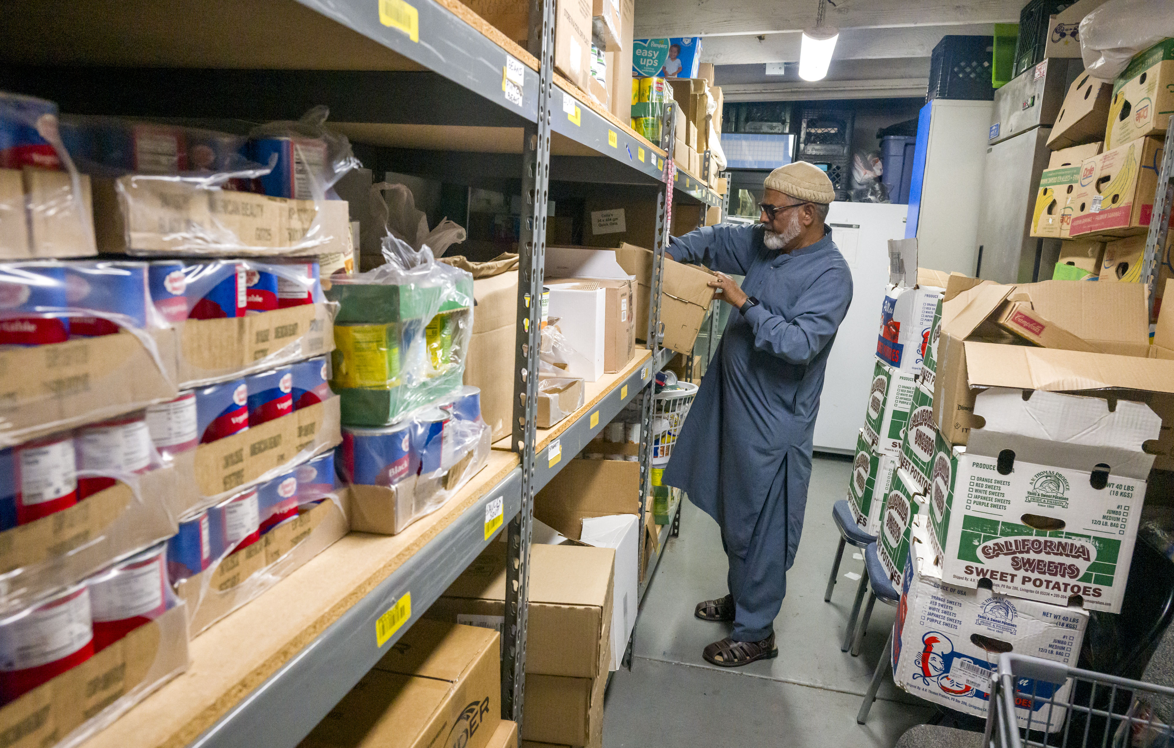 Nayyer Alam of Friends of Humanity organizes the food pantry...