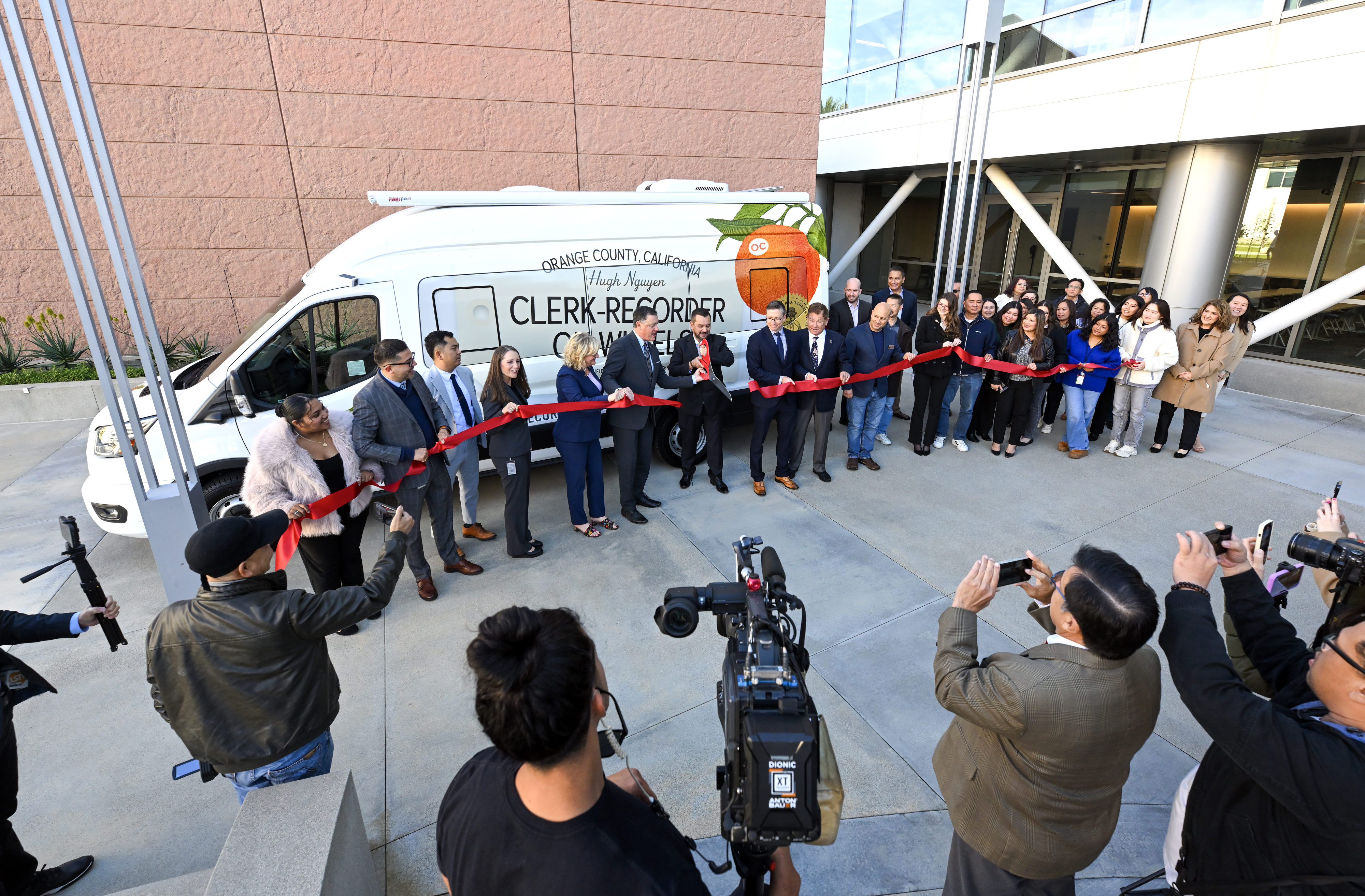 Orange County Clerk-Recorder Hugh Nguyen joins other officals as he...