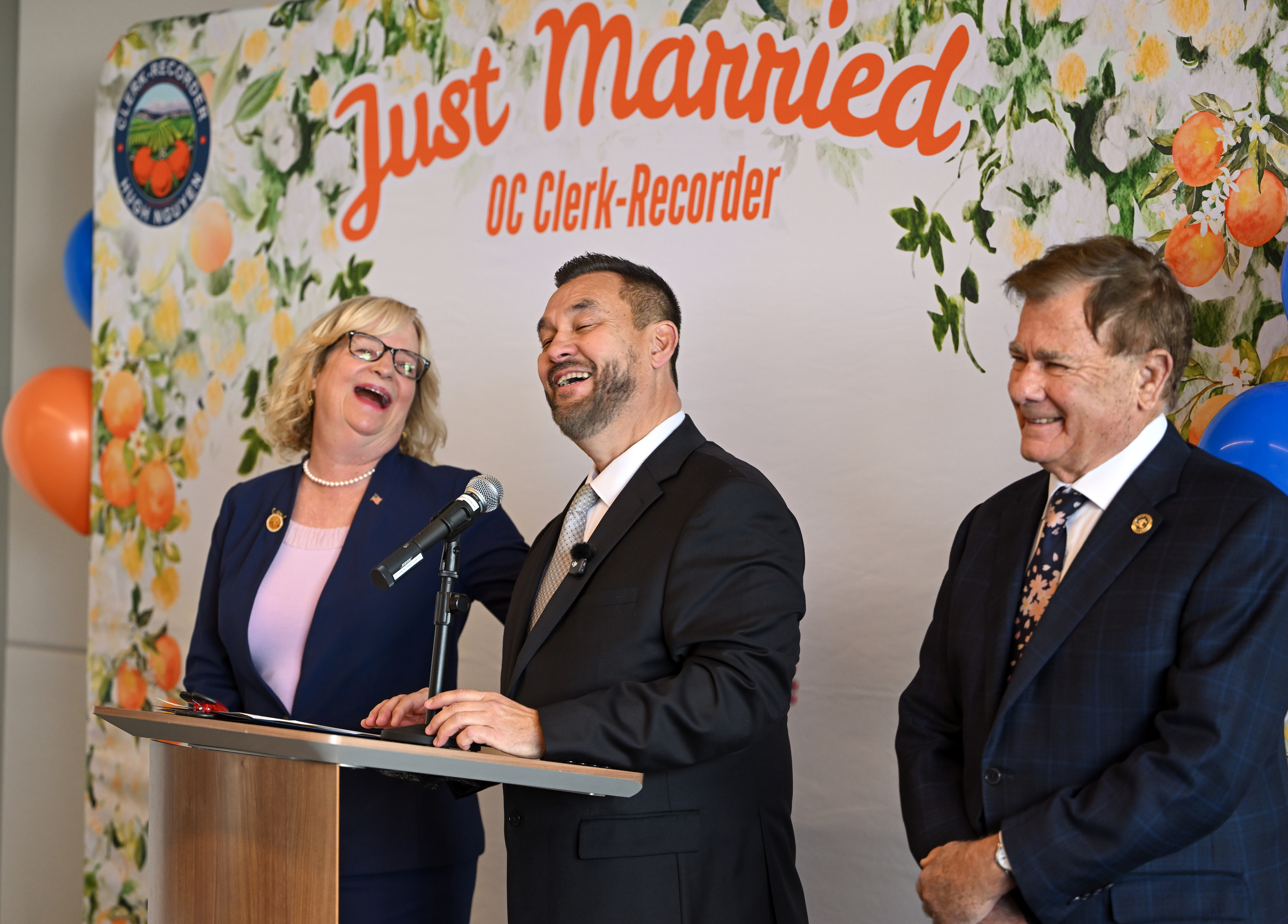 Orange County Clerk-Recorder Hugh Nguyen, center, shres a laugh with...