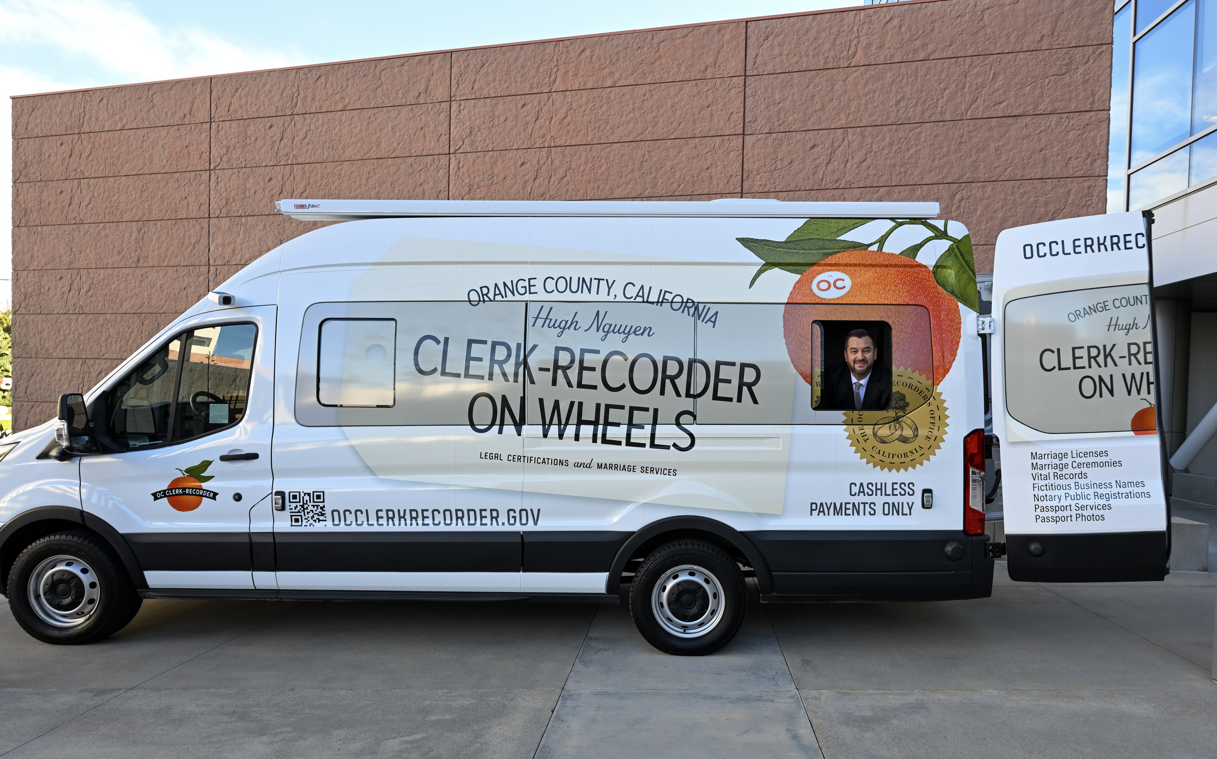 Orange County Clerk-Recorder Hugh Nguyen insdie thier new mobile van...