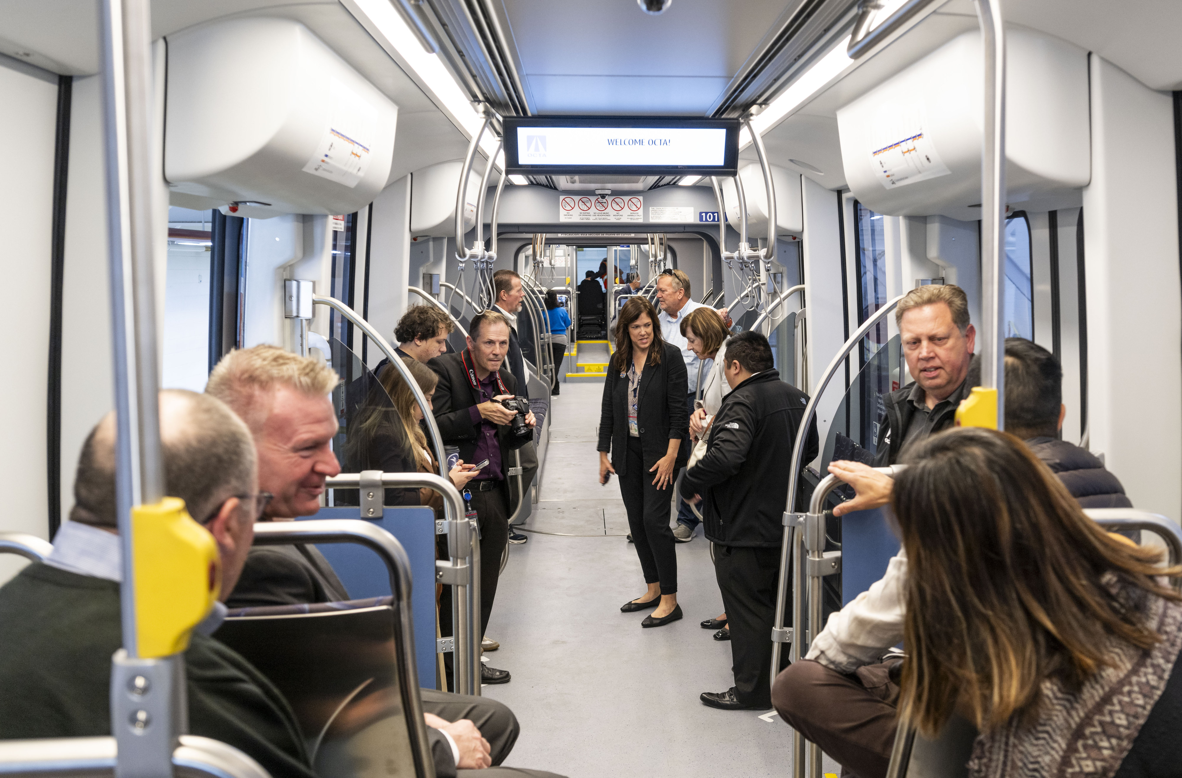 Officials tour the first streetcar at the Orange County Transportation...