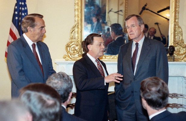 Sen. John Seymour (R-Calif.), center gestures while talking to President George Bush on Capitol Hill in Washington to discuss the situation in Los Angeles, May 5, 1992. The president told reporters he was doing "a lot of listening, talking, and explaining where we stand on the federal side on L.A." Senate Minority Leader Bob Dole of Kansas looks on at left. (AP Photo/John Duricka)