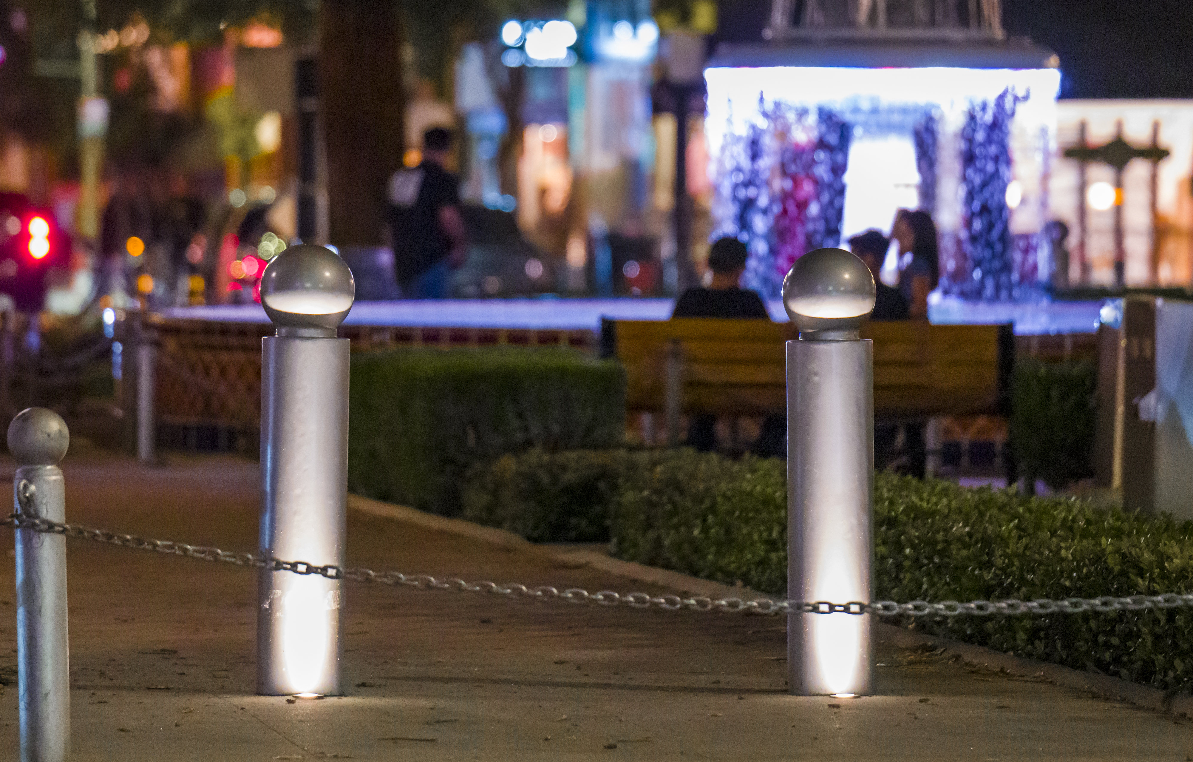 Lighted bollards are placed around Plaza Square Park in the...