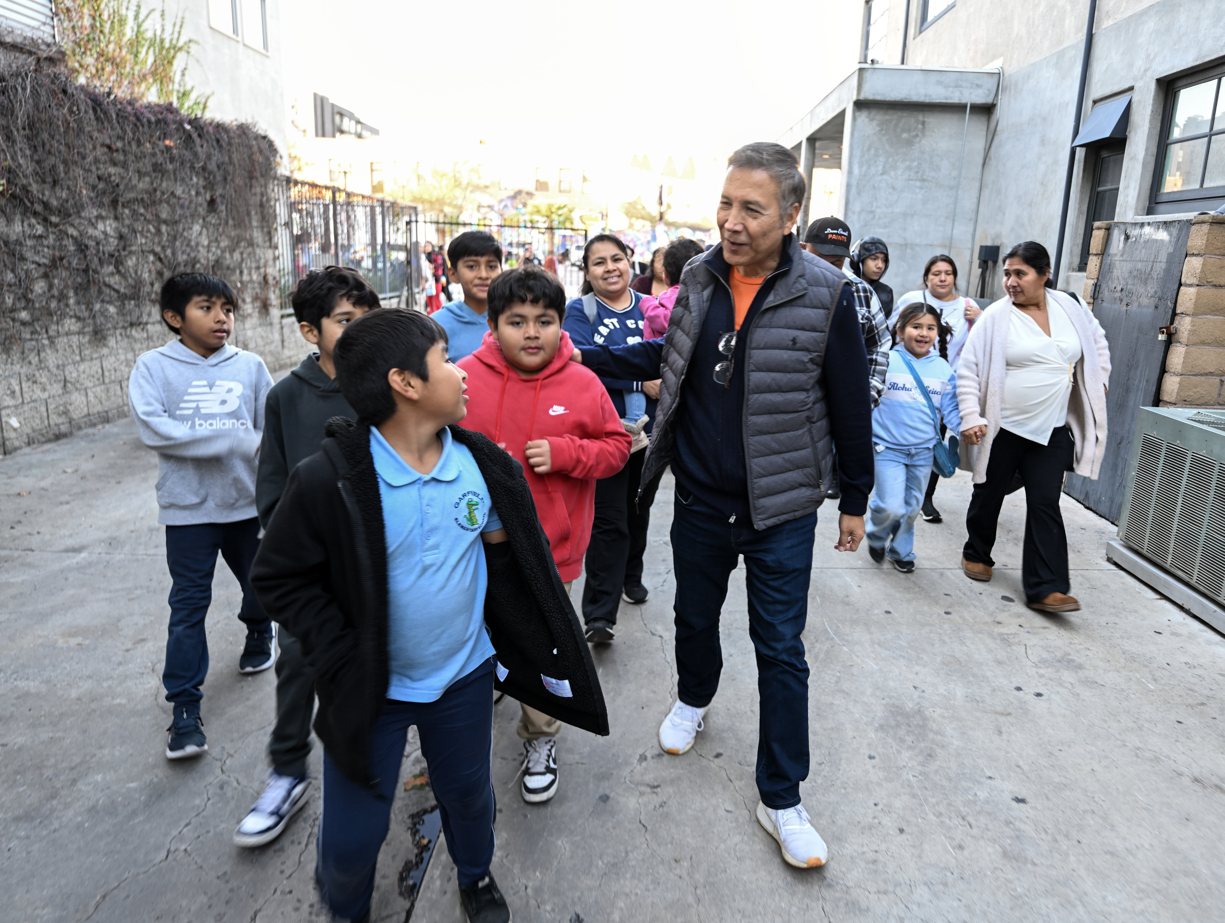 Orange County Supervisor Vicente Sarmiento walks kids in to the...
