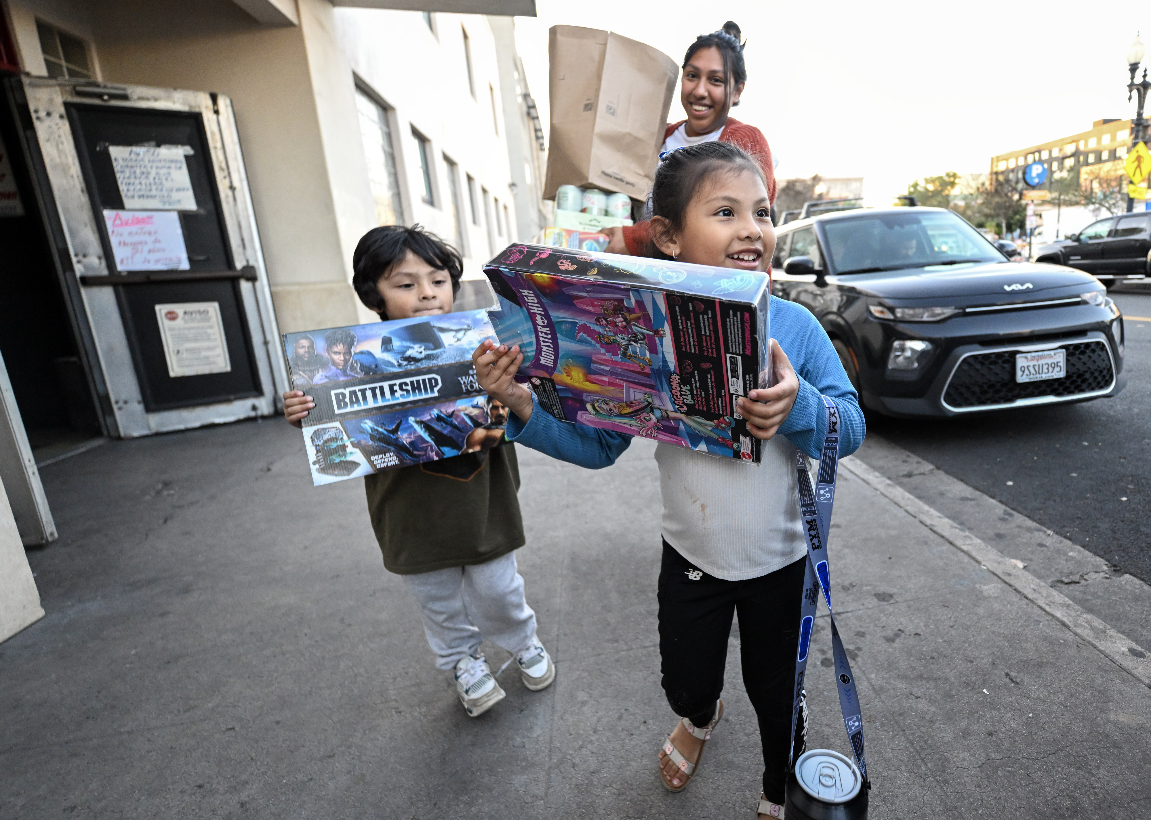Khyrah Olivares, 5, and her brother, Joel Olivares, 4, walk...