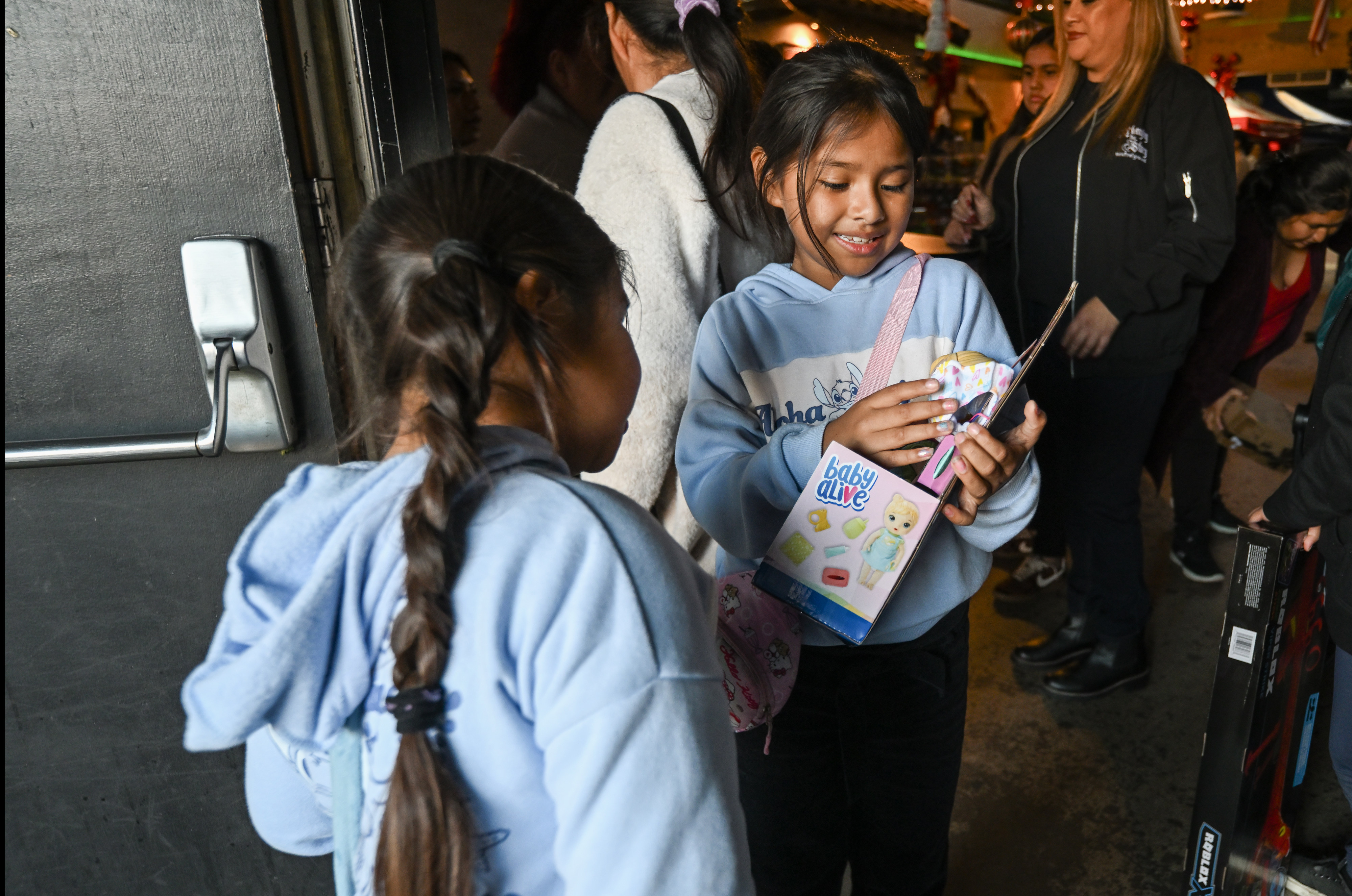 Ayleen Sandoval checks out a doll she got during the...