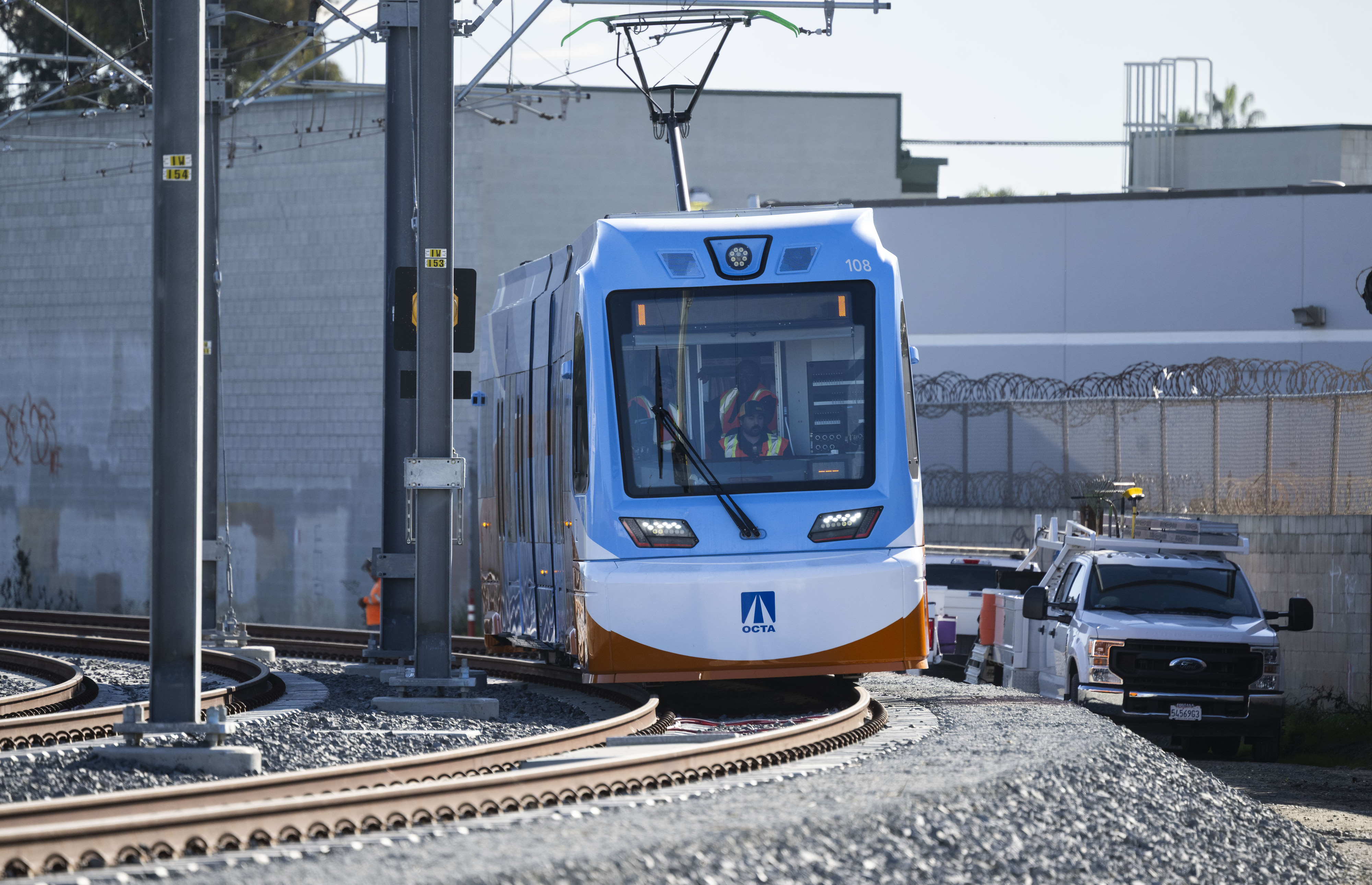 An OC Streetcar train moves along testing tracks near W....
