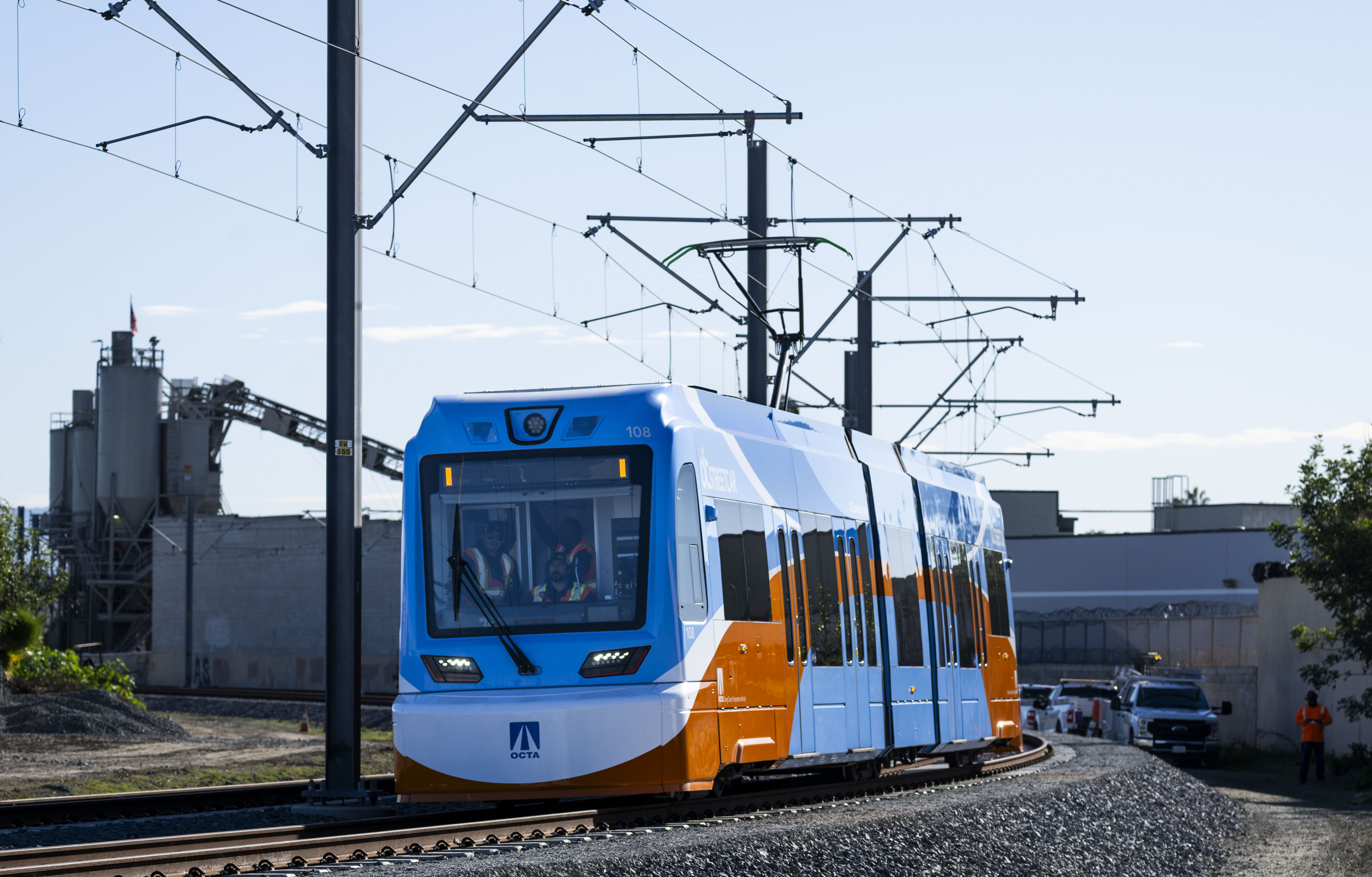 An OC Streetcar train moves along testing tracks near W....