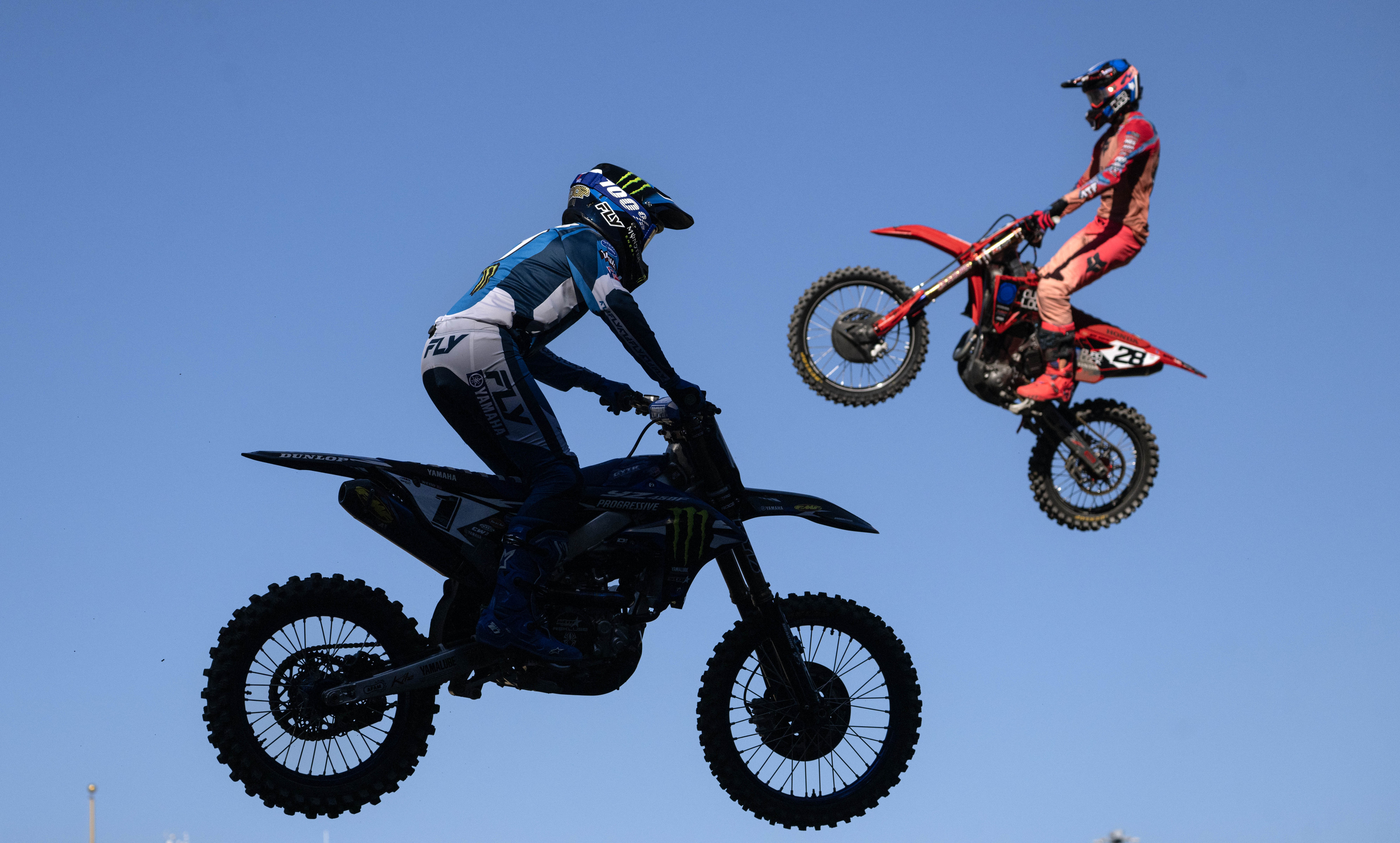 Cooper Webb, left, crosses paths with Christian Craig during the...