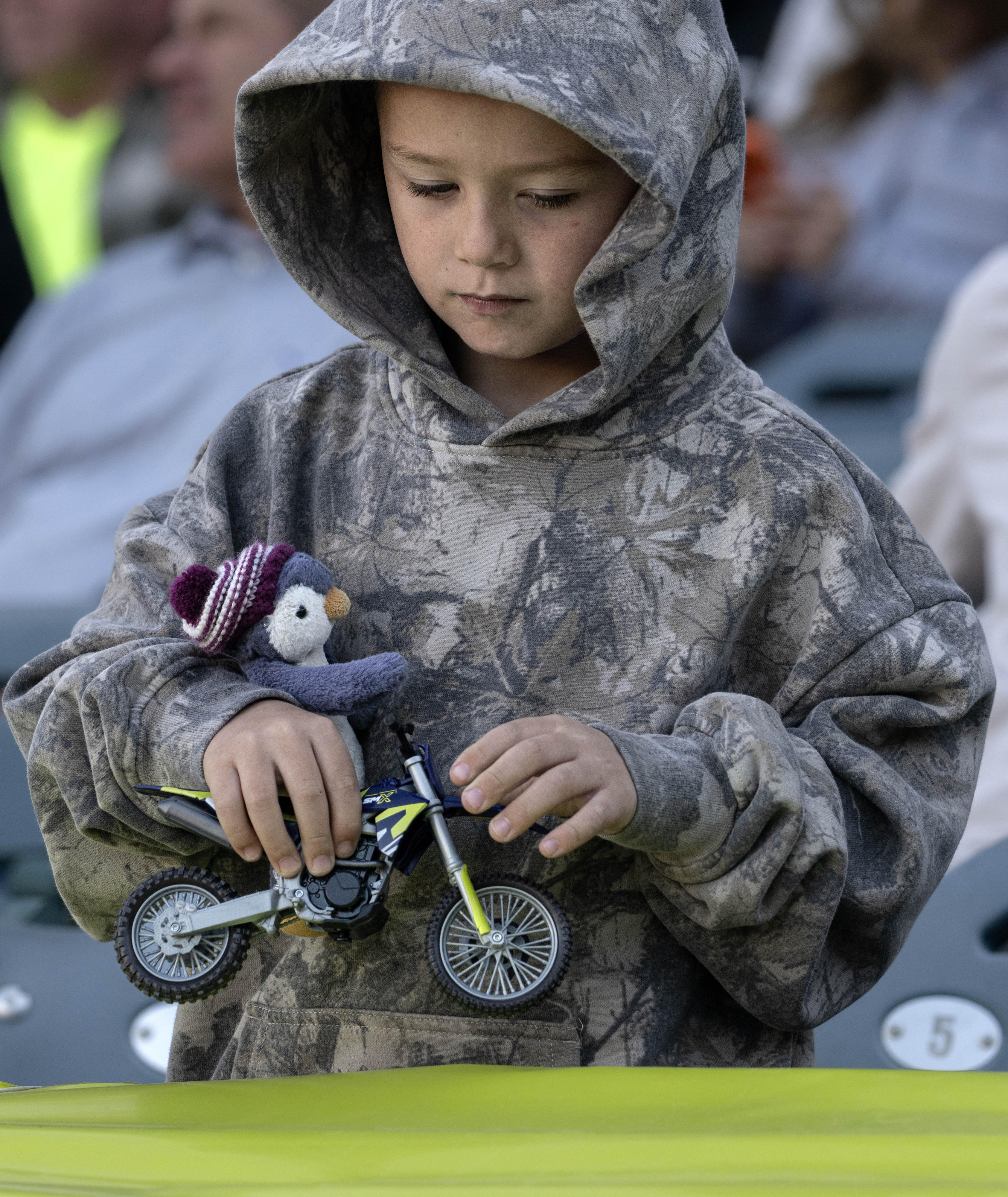 Six-year-old Kane Gilbert plays with his toy motorcycle as he...