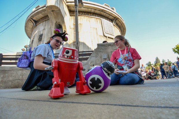 Isabel Luck and her sister, Elizabeth Luck, play with remote control droids they built at Droid Depot on opening day at Star Wars: Galaxy's Edge at Disneyland in Anaheim, CA, on Friday, May 31, 2019. (Photo by Jeff Gritchen, Orange County Register/SCNG)
