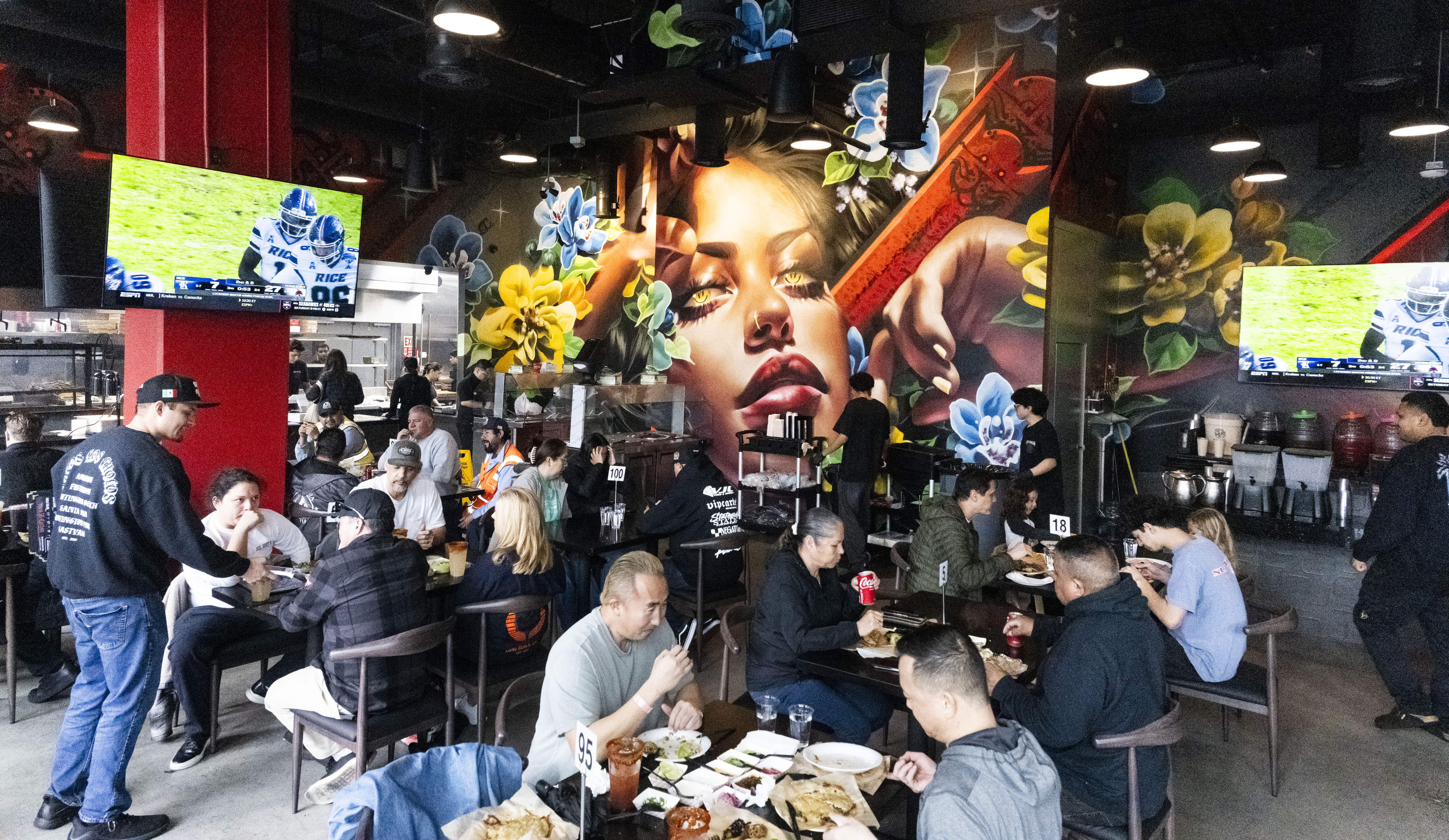 Diners eat at Tacos Los Cholos in Santa Ana, CA...