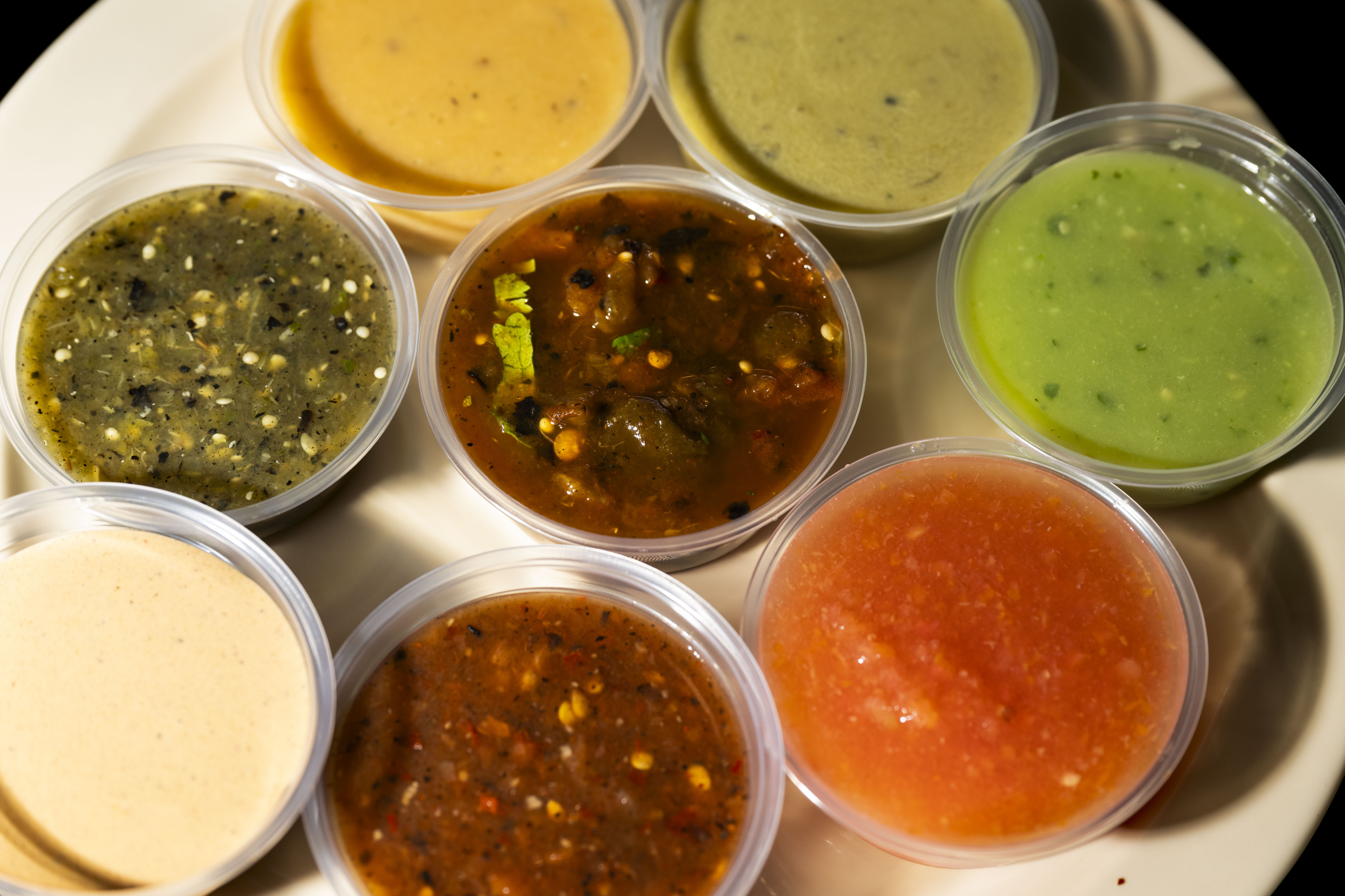 Tacos Los Cholos offers a variety of sauces at their...