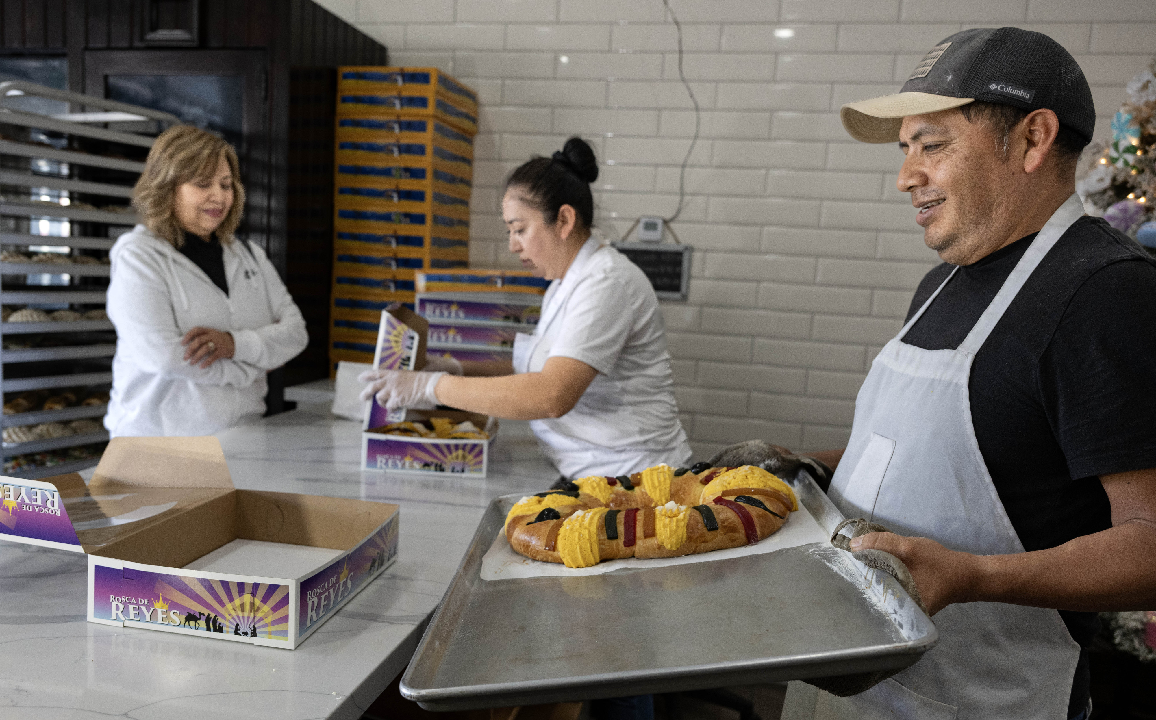 Carmen Mendoza waits on long-time customer Cathy Ambriz while Antonio...