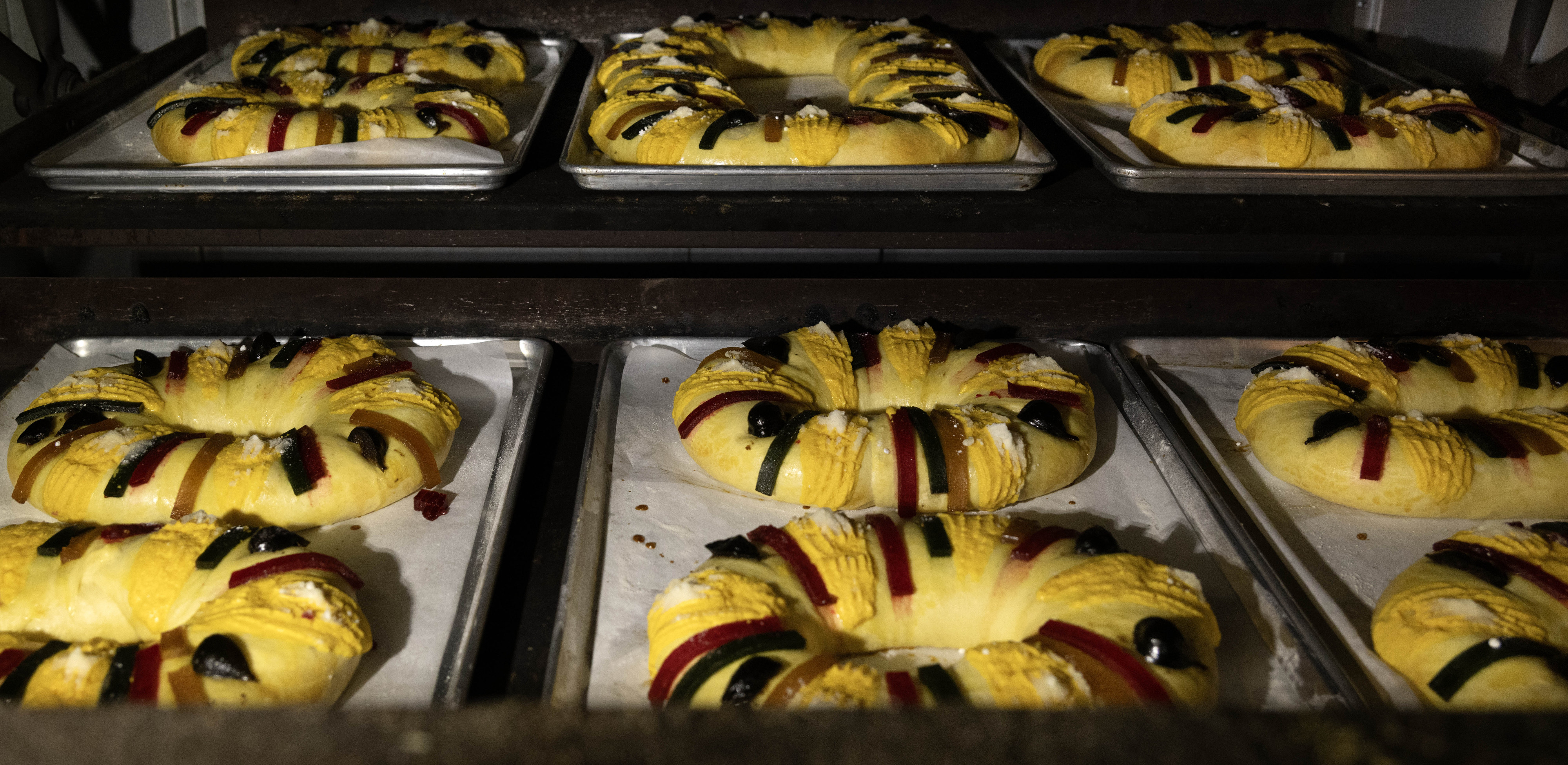 Dozens of Three Kings Bread rotate in an oven at...