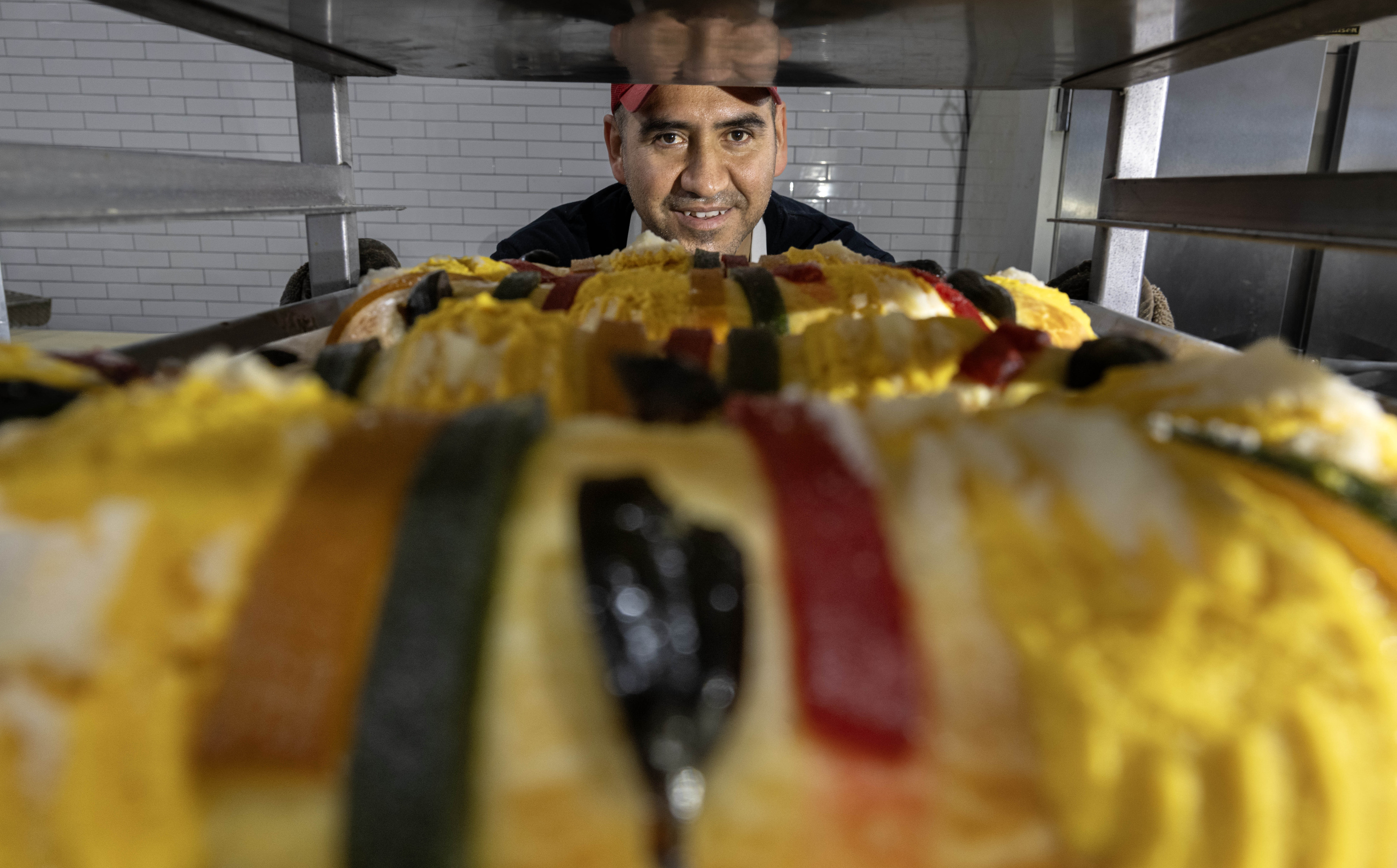 Jovian Mendoza, a baker at Max’s Bakery in Anaheim, stacks...