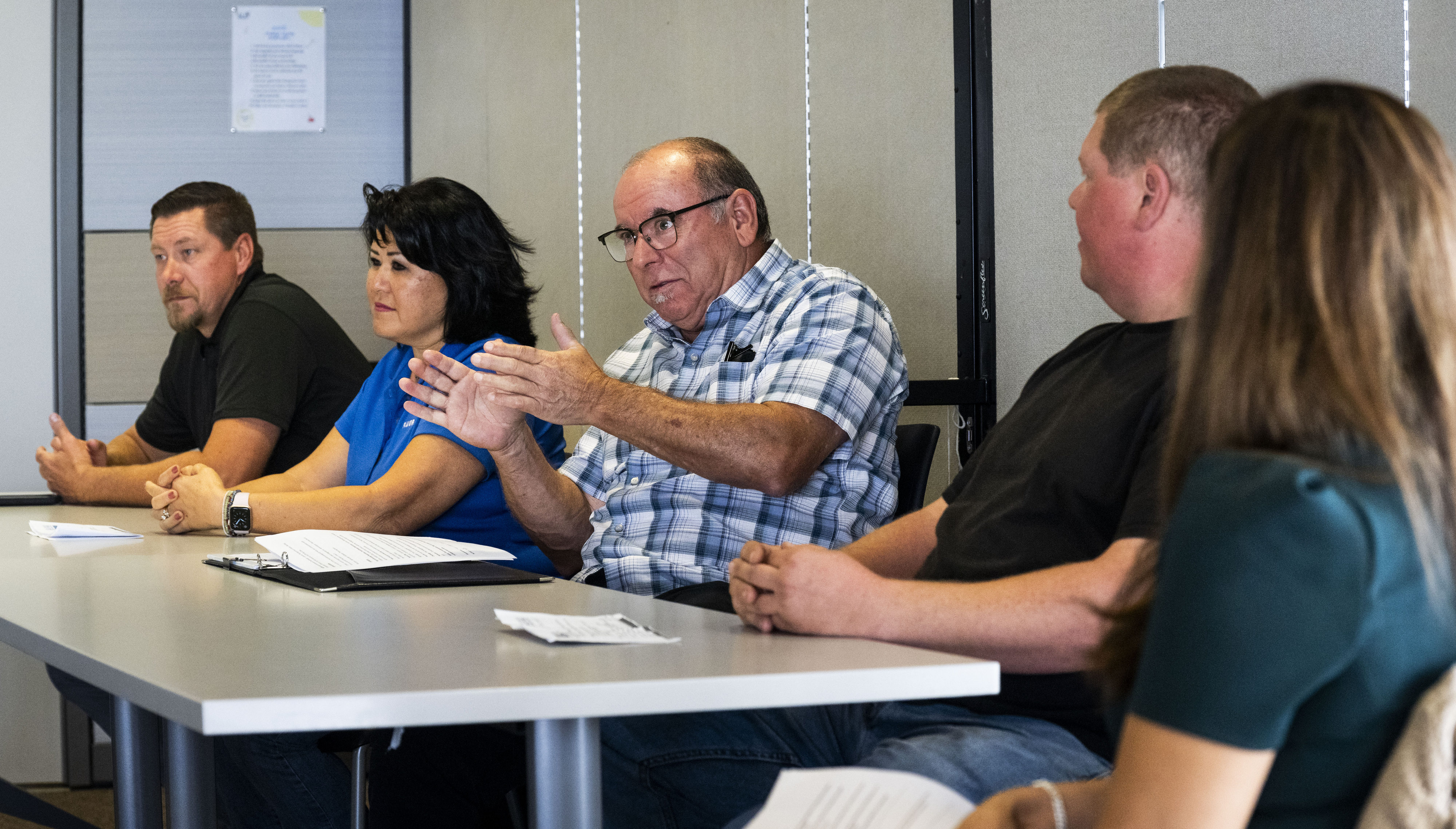 Robert J. Mosqueda from the Laborers Training School, center, speaks...