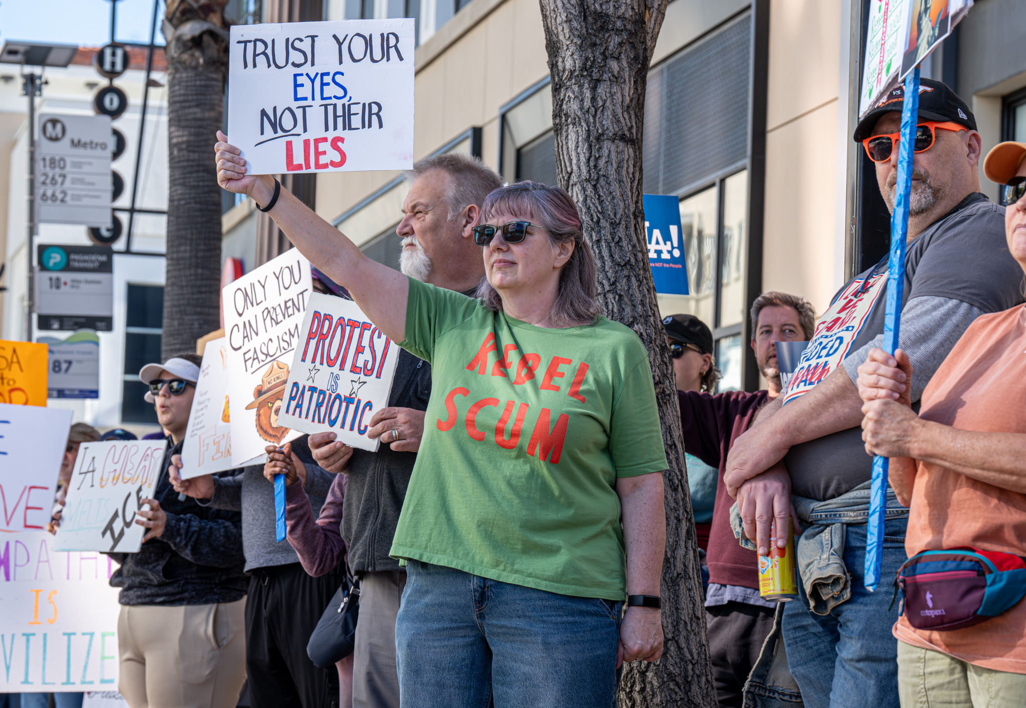 An Edkins holding up a sign saying âTrust Your Eyes...