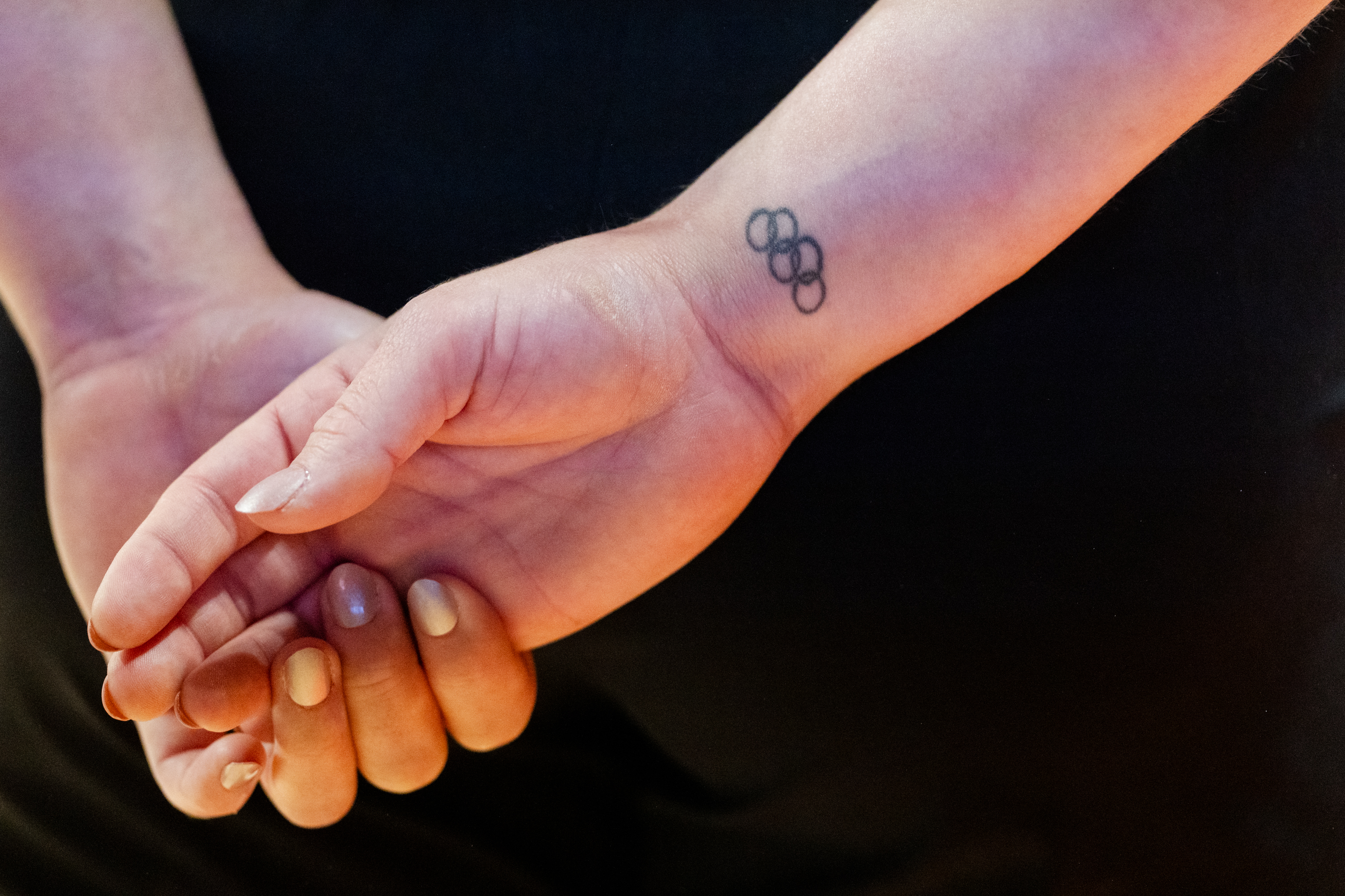 An Olympics rings tattoo detail shot of Student Assistant Coach Jade Carey of the Oregon State Beavers during a gymnastics meet against the Sacramento State Hornets at Gill Coliseum on January 16, 2026 in Corvallis, OR.