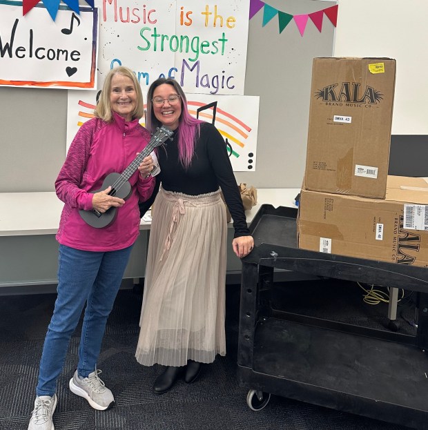 Ramona ukulele instructor Karla Brustad, left, opened boxes of new ukuleles with James Baldwin Elementary School music teacher Monica Allen in early December. (Courtesy Jessica Brustad)