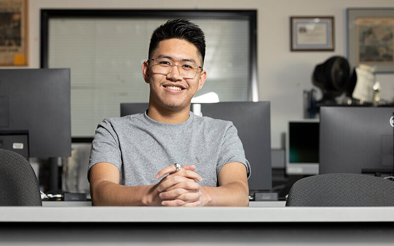 Cal State Fullerton student Raniel Santos, an aspiring journalist, sits in the Daily Titan newsroom.