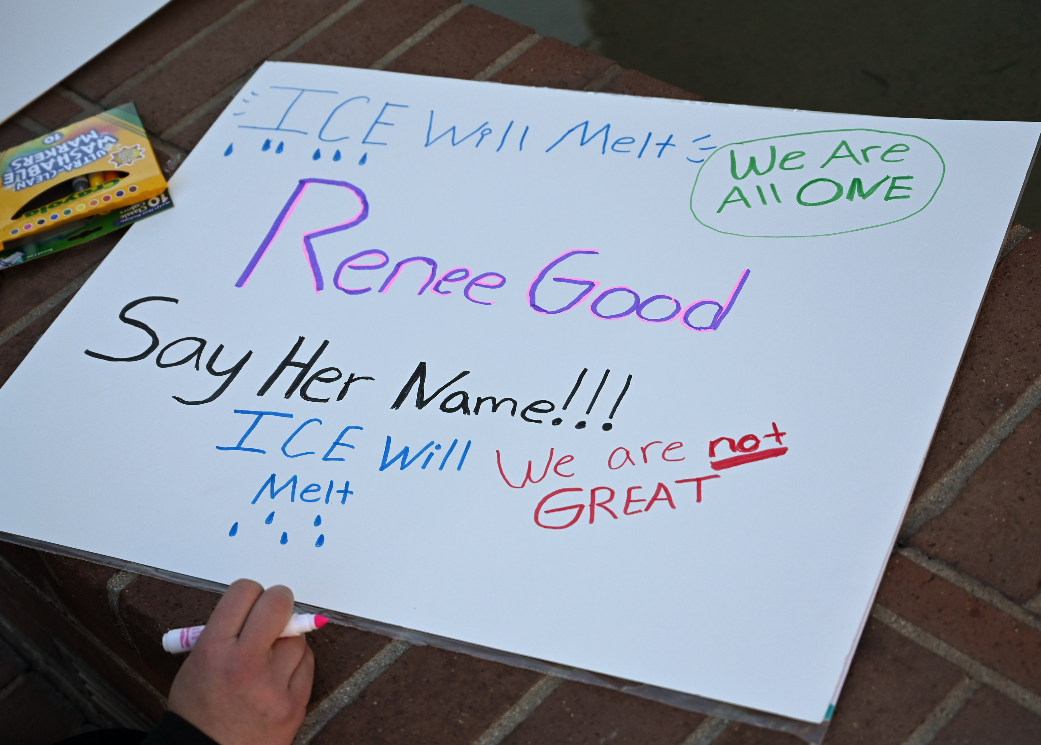 A protester makes a sign on Saturday, Jan. 10, 2026,...