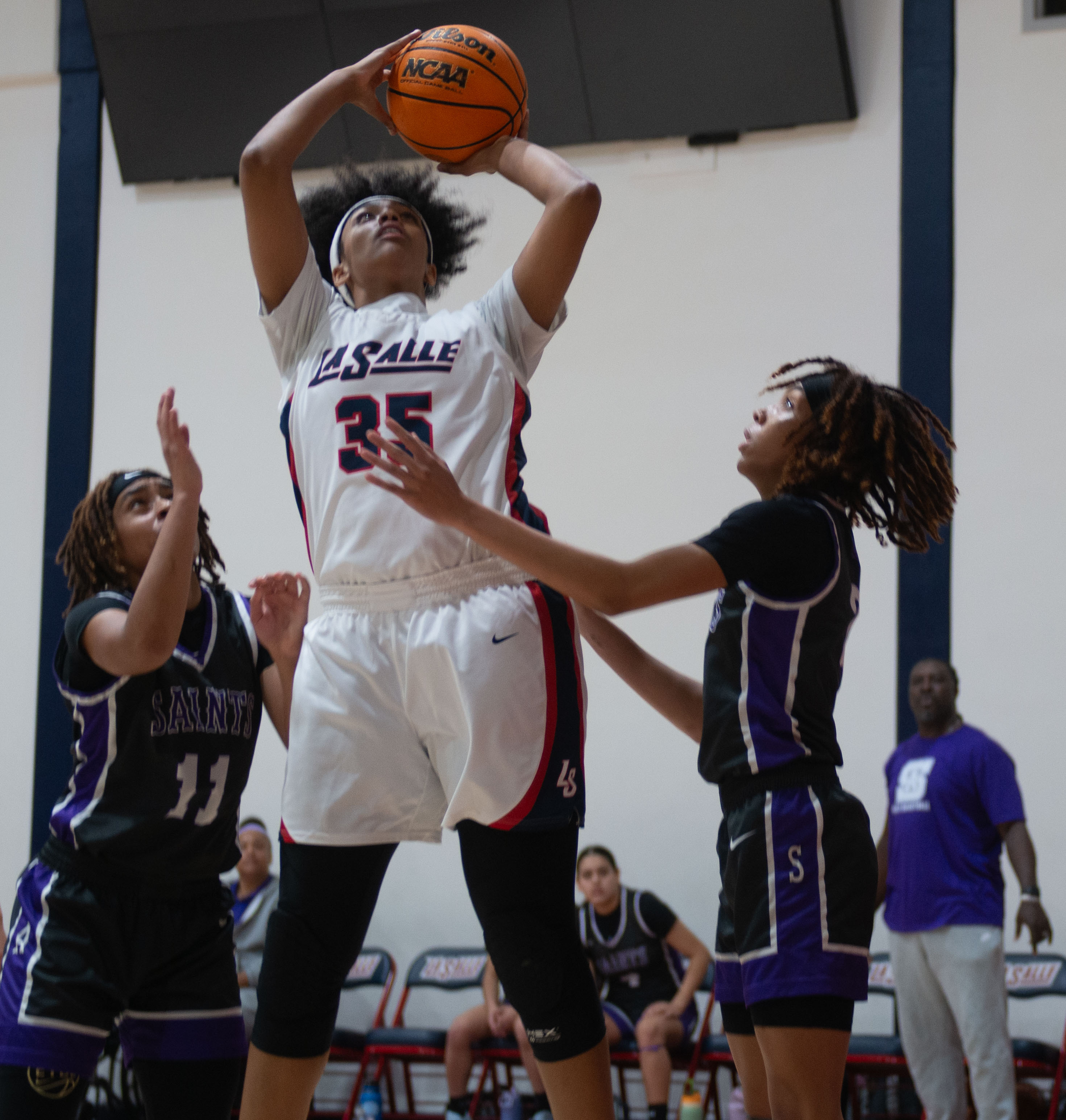 La Salle’s Riley Higgins puts the ball up over St....