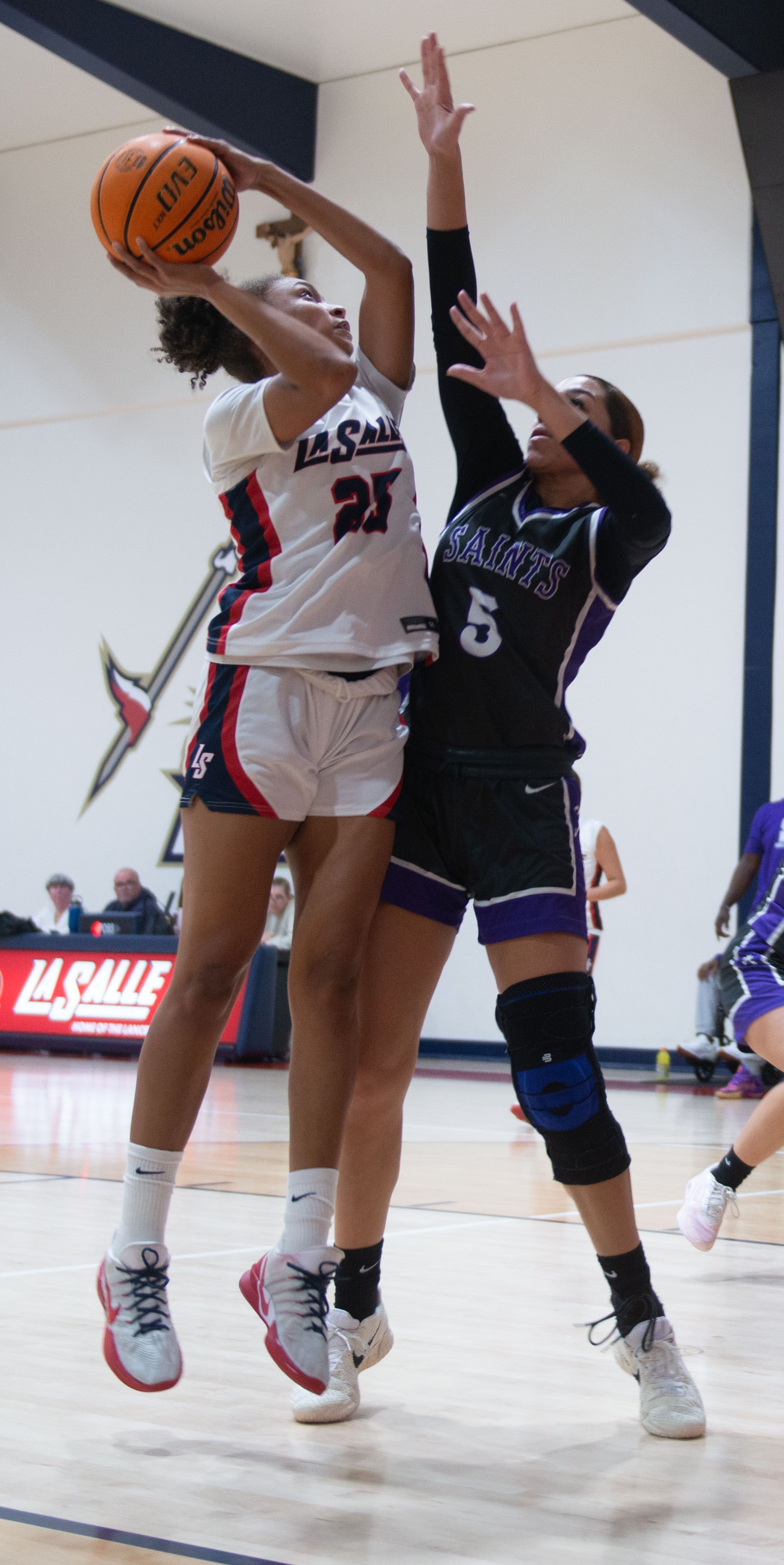 La Salle’s Riley Higgins puts the ball up over St....