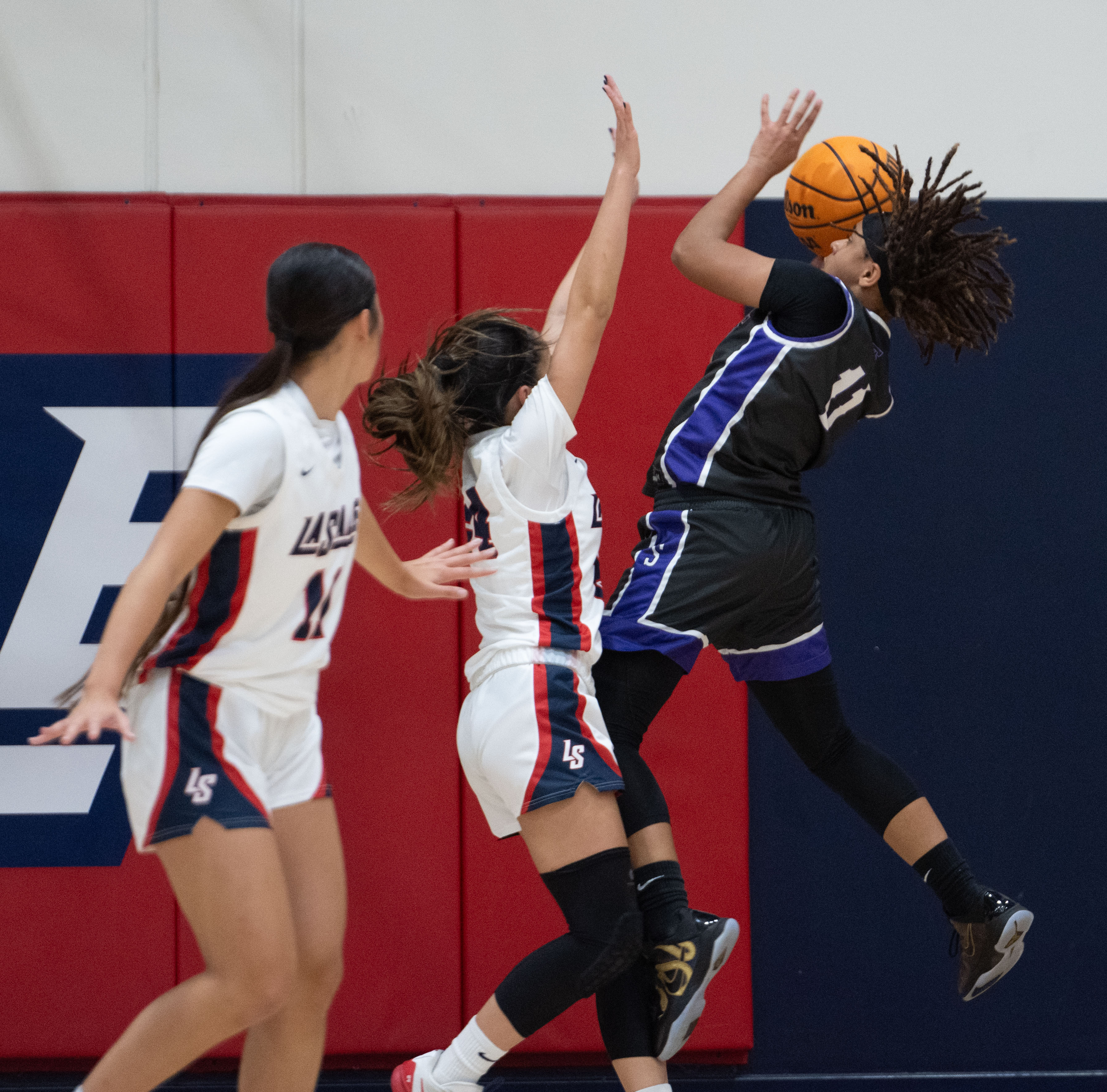 St. Anthony’s Jordyn Washington tries to put the ball up...