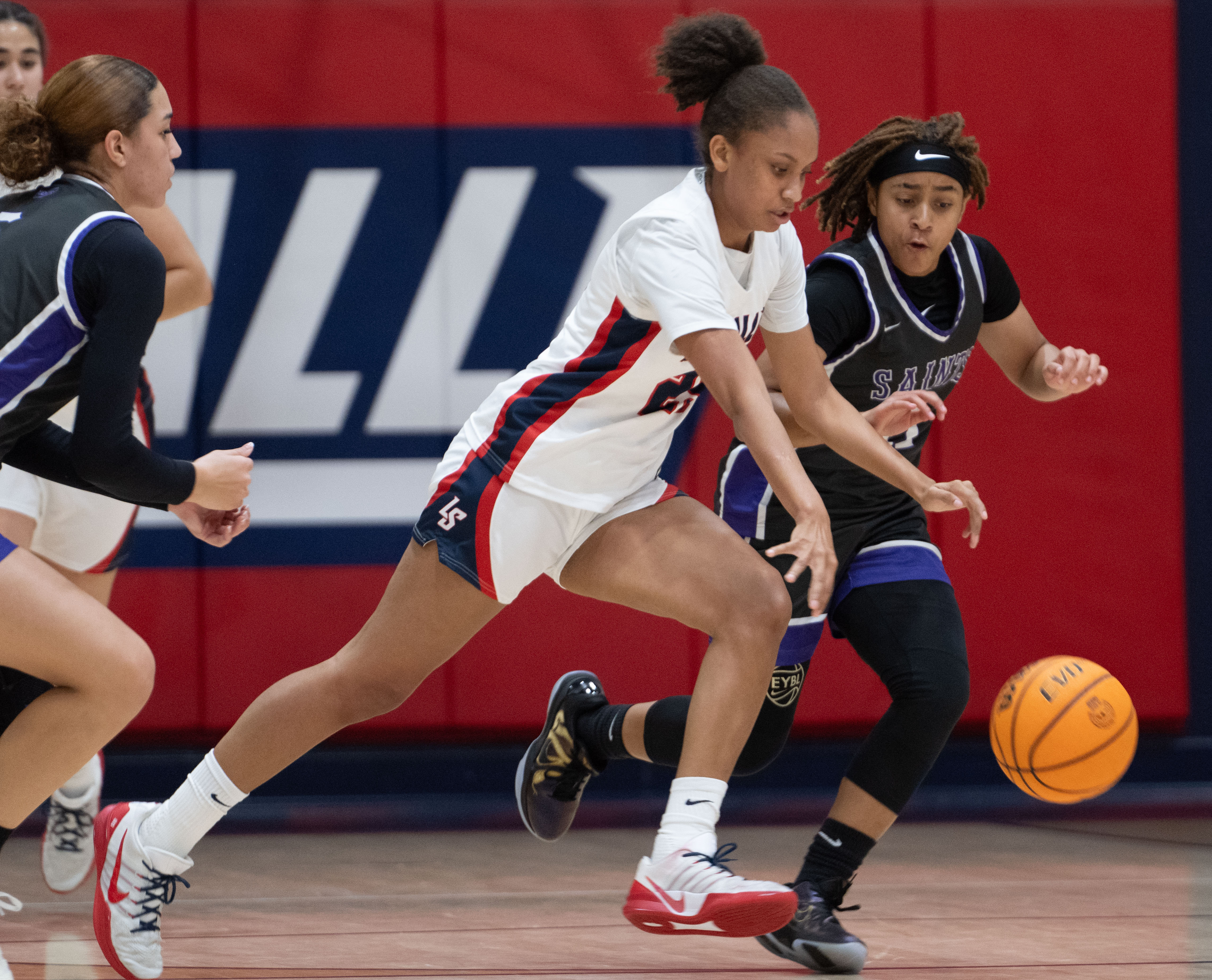 La Salle’s Riley Higgins moves the ball down the court...