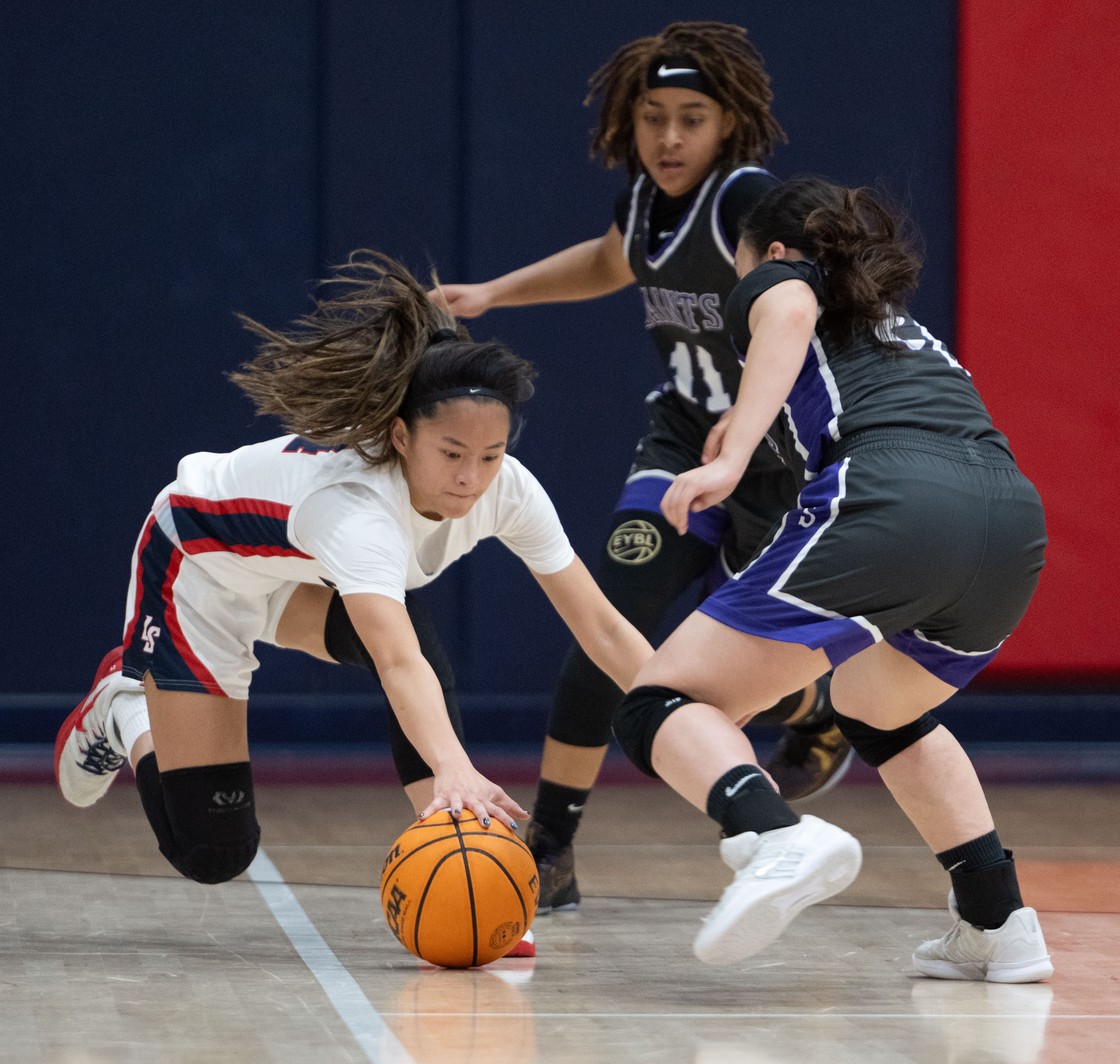 La Salle’s Emily Fong leaps for the loose ball ahead...