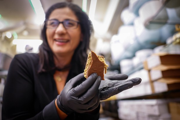 Sharona Laherrere, owner, holds a piece of one of her Dubai chocolate bars at Sharona's Chocolate Shop in San Mateo, Calif., on Wednesday, Jan. 28, 2026. (Shae Hammond/Bay Area News Group)