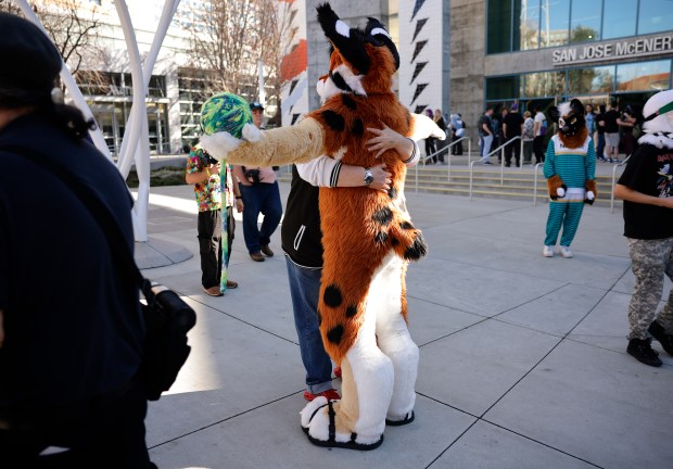 FluxPaw, from San Diego, who preferred to give their character name only, gets a hug at Further Confusion, also known as FurCon, outside of the San Jose McEnery Convention Center in downtown San Jose, Calif., on Sunday, Jan. 18, 2026. (Nhat V. Meyer/Bay Area News Group)