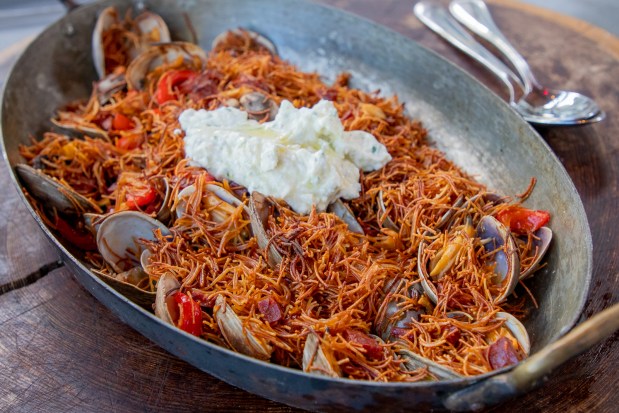 A Meyhouse dish of roasted erishte is a Turkish handmade egg pasta with clams, sucuk (spicy dried sausage) and saffron topped with an herb sauce. (Photo by Isabel Baer for Meyhouse)