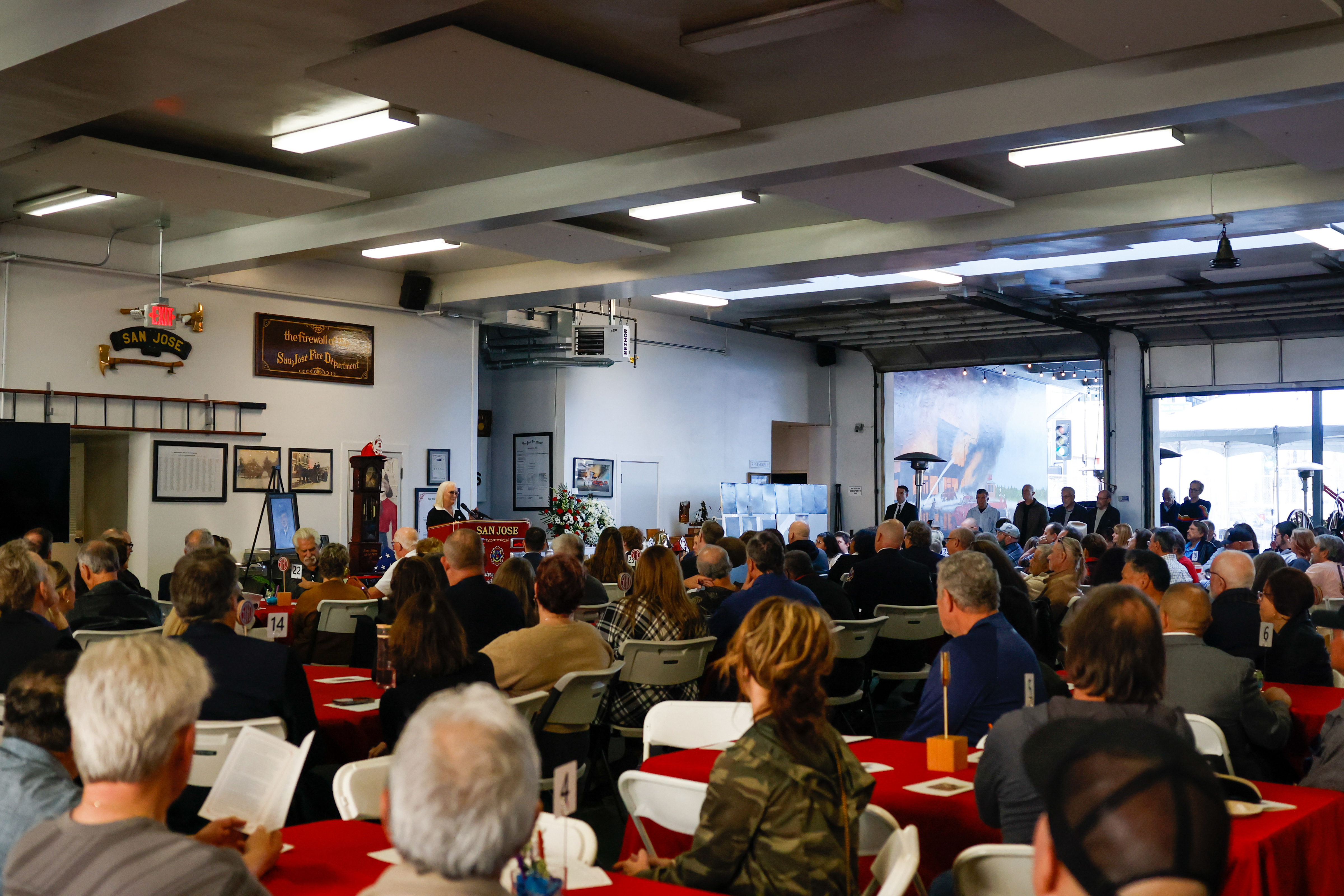 People gather during a memorial for Sam Seibert, a retired...