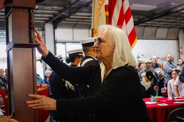 Doreen Below, Sam Seibert's nice, places Seibert's ashes into a memorial grandfather clock during his celebration of life ceremony at the San Jose Fire Museum in San Jose, Calif., on Tuesday, Jan. 6, 2026. Sam Seibert was a retired San Jose Fire Captain who died at age 106. (Shae Hammond/Bay Area News Group)