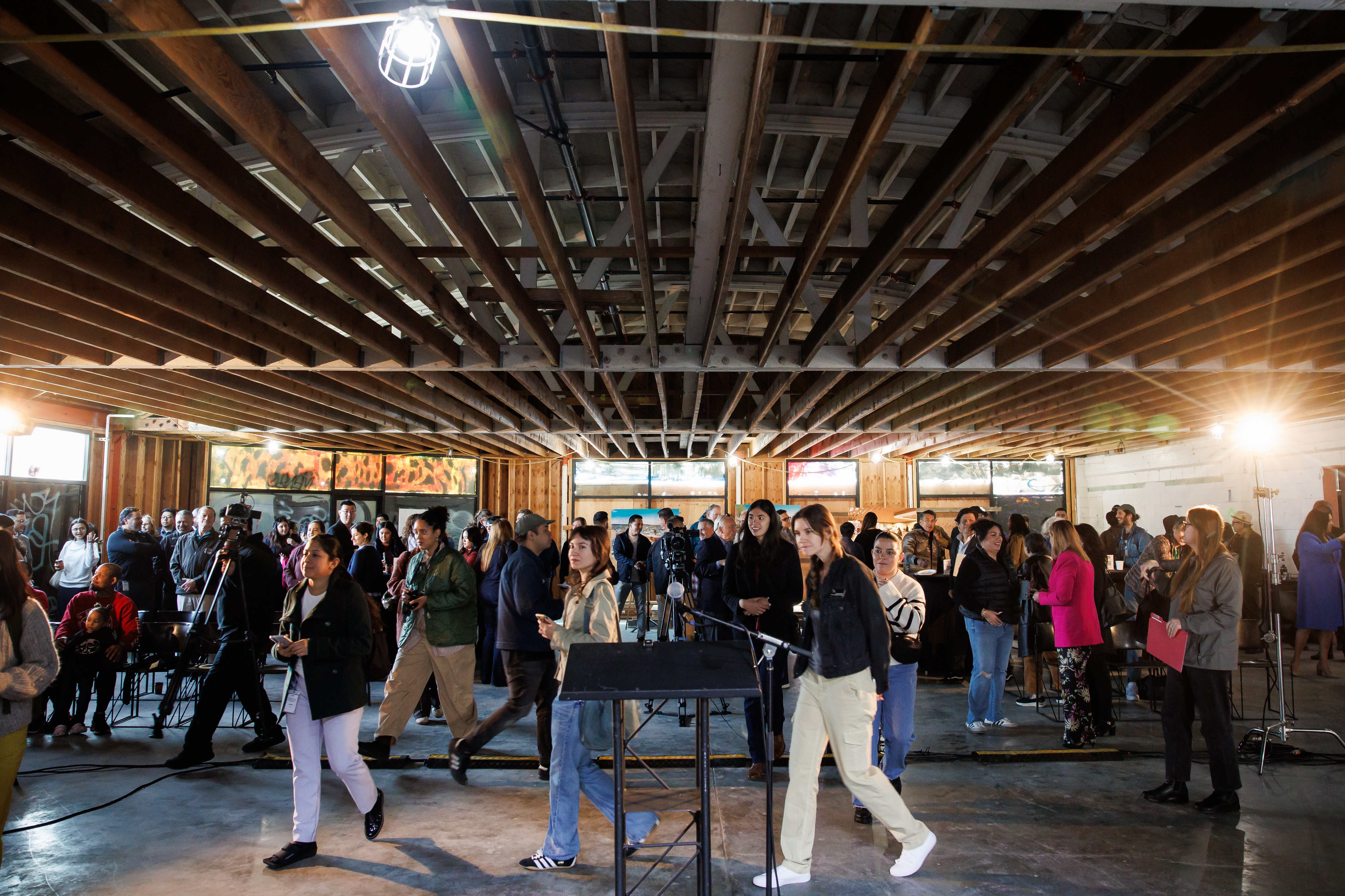 People attend a community event regarding the construction of La...