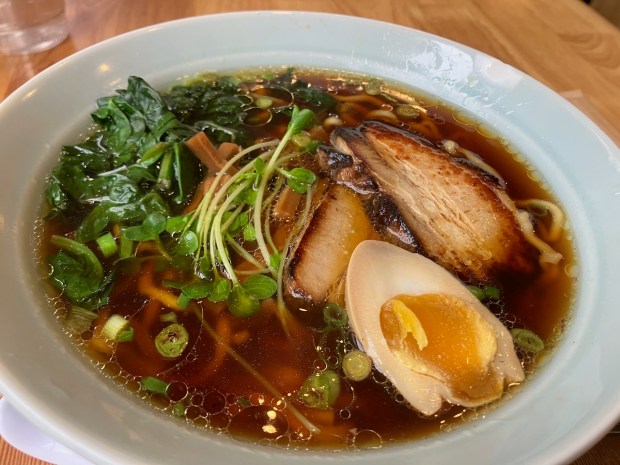 The shoyu ramen at HiroNori Craft Ramen in San Mateo is served in chicken broth with two-year barrel-aged soy sauce, pork chashu, green onion, spinach, bamboo, kaiware sprouts and half an egg. Garlic and a house spicy sauce are available as additional toppings for free. (Kate Bradshaw/Bay Area News Group)