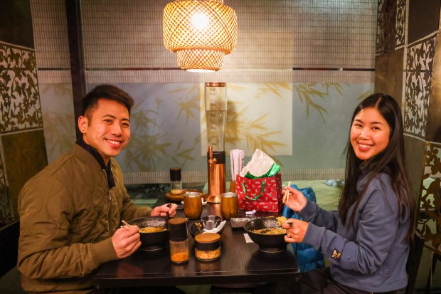 Brendon Luu, of San Jose, and his friend Christina Leung, of Foster City, enjoy bowls of black garlic tonkotsu ramen at Tsukira Ramen in Foster City, Calif., on Thursday, Jan. 8, 2026. (Ray Chavez/Bay Area News Group)