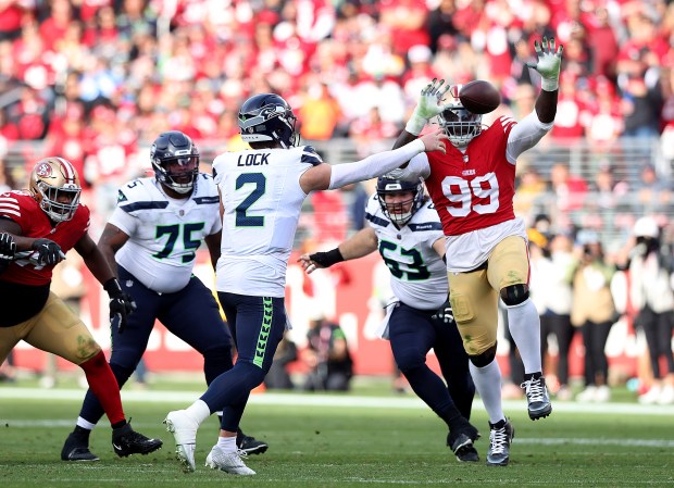 Seattle Seahawks quarterback Drew Lock (2) is pressured by San Francisco 49ers' Javon Kinlaw (99) in the first quarter at Levi's Stadium in Santa Clara, Calif., on Sunday, Dec. 10, 2023. (Karl Mondon/Bay Area News Group)