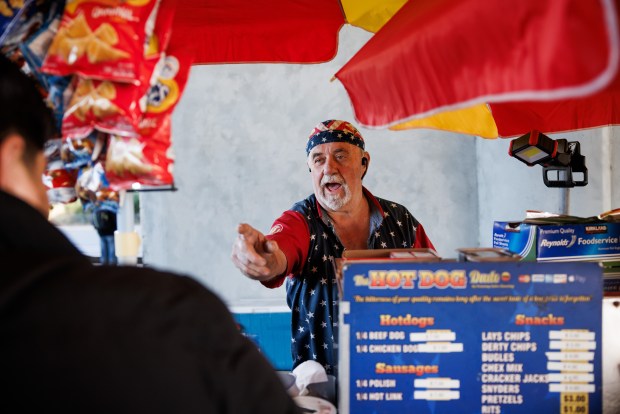 Hot dog vendor Howard Gibbins, also known as "The Hot Dog Dude," chats with a customer at the Santa Clara-Great America station near Levi's Stadium in Santa Clara, Calif., Wednesday, Jan. 7, 2026. (Dai Sugano/Bay Area News Group)