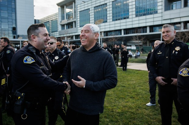 A San Jose police sergeant, center, who has been with the department for 13 years, was released from the hospital to a crowd of supporting fellow officers at Santa Clara Valley Medical Center on Thursday, Jan. 22, 2026. The sergeant suffered a gunshot wound to his head during a shootout with a man suspected in a robbery and carjacking spree over the past week. (Dai Sugano/ Bay Area News Group)