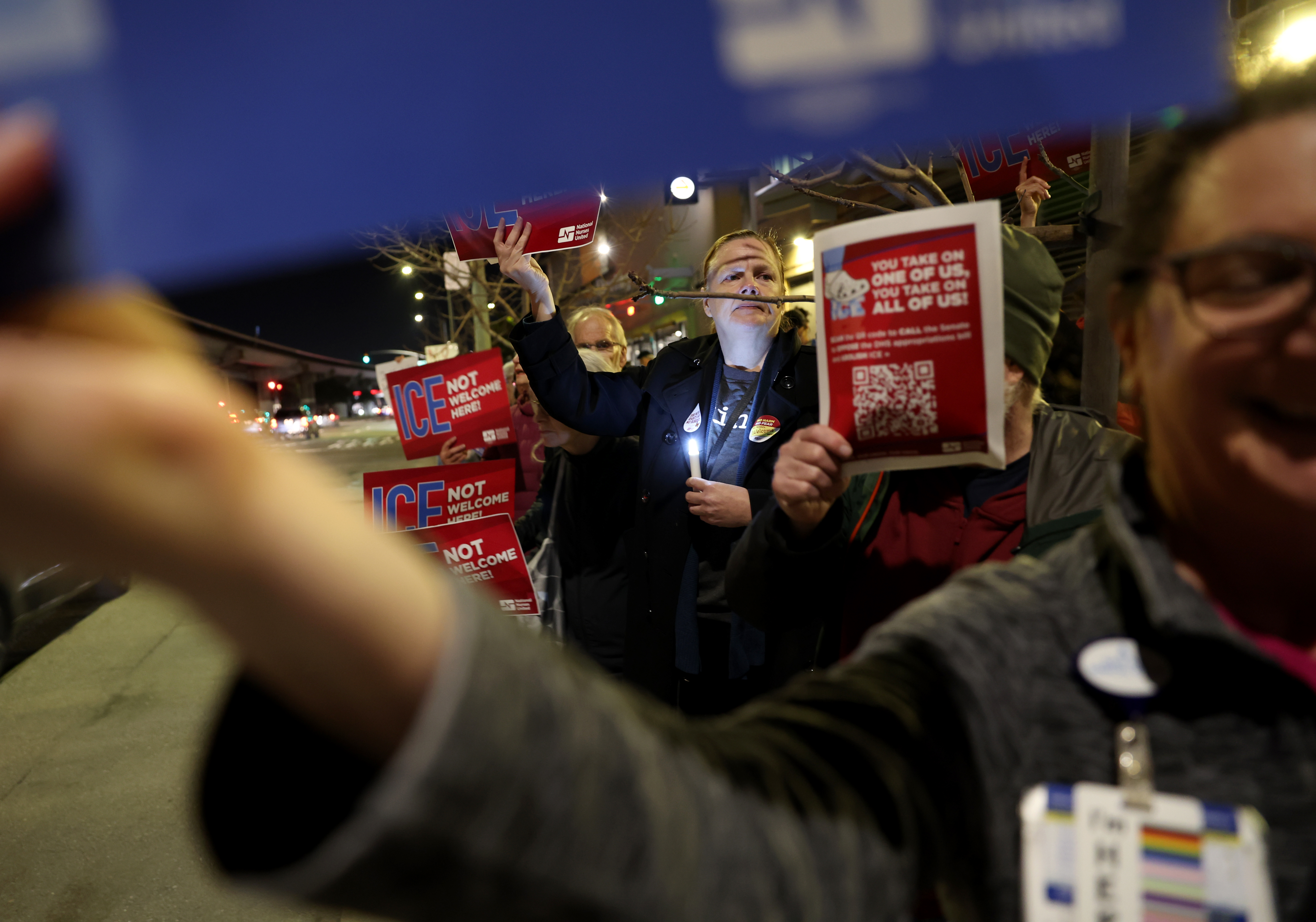 Healthcare professionals and community members attend a protest outside of...