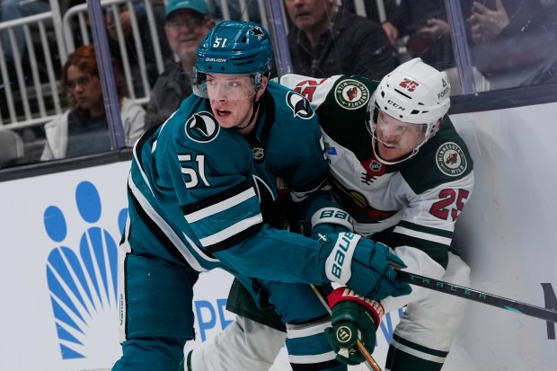 San Jose Sharks right wing Collin Graf (51) and Minnesota Wild defenseman Jonas Brodin (25) collide during the first period of an NHL hockey game, Wednesday, Dec. 31, 2025, in San Jose, Calif. (AP Photo/Godofredo A. VÃ¡squez)