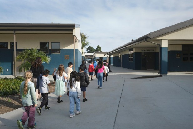 At schools such as Mission Elementary, where students are seen walking to class on Dec. 18, 2025, Oceanside Unified has been working to label non-public areas that are off-limits to federal officers. (John Gastaldo / For the San Diego Union-Tribune)