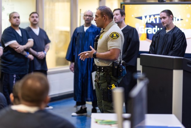 Deputy Luis Meraz speaks to participants in the Vista jail's medication-assisted treatment program on Tuesday, Dec. 16, 2025, just after their performance of their play "The Untold Story of the Grinch." He bought pizza for the group after the show. (San Diego Sheriff's Office)