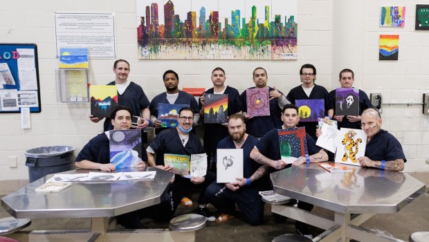 Participants in the Vista jail's medication-assisted treatment program pose with their artwork on Monday, Dec. 22, 2025. A mental-health clinician meets with each participant weekly, runs several therapy groups and leads art therapy sessions. (San Diego Sheriff's Office)