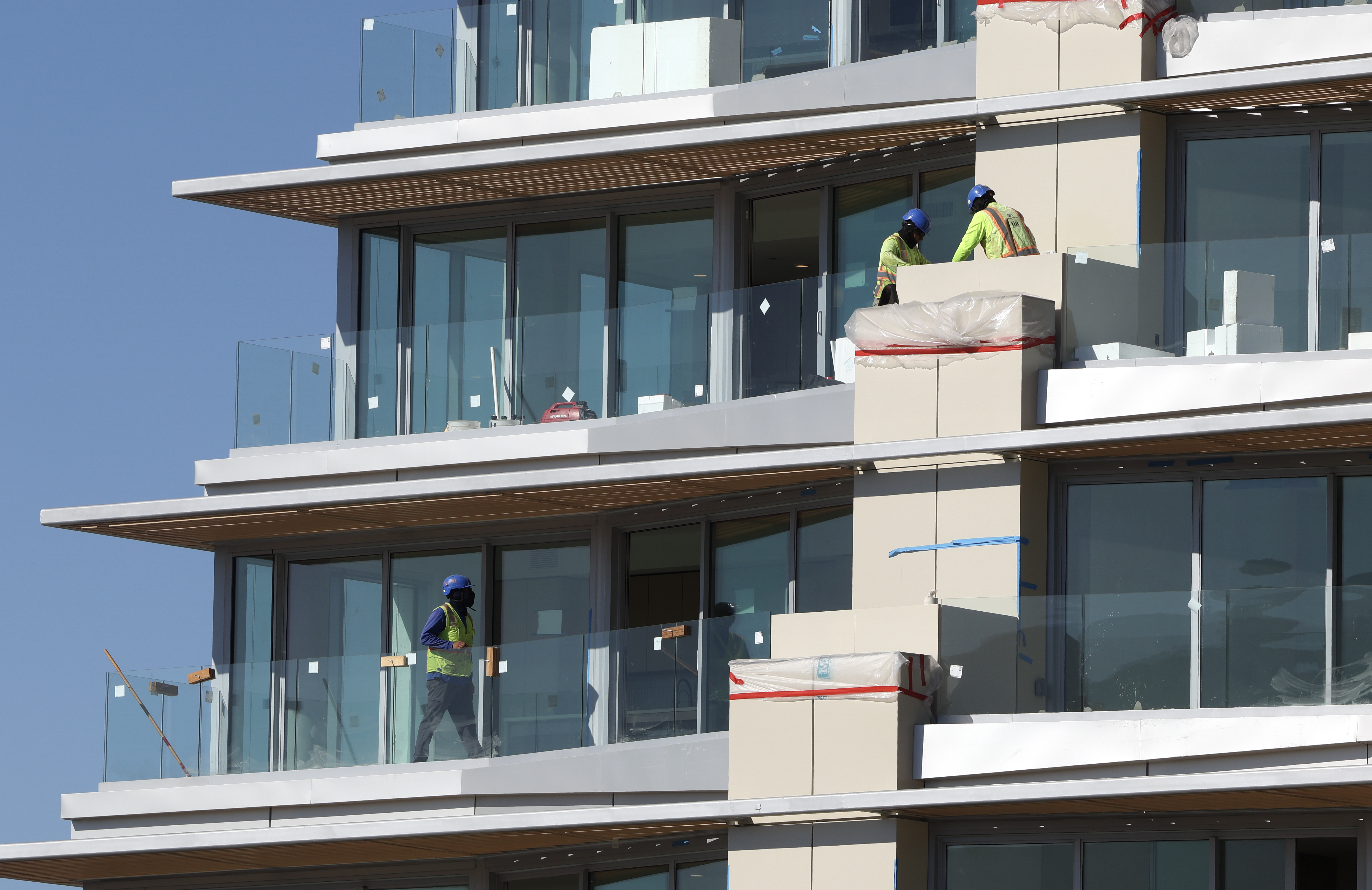 Construction personnel work to finish the 222 North City building,...