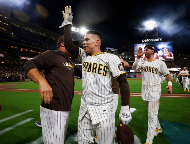 Freddy Fermin #54 of the San Diego Padres and Jackson Merrill #3 celebrate after a walk-off win in the eleventh inning to beat the Milwaukee Brewers at Petco Park on Sept. 22, 2025 in San Diego, CA. (K.C. Alfred / The San Diego Union-Tribune)